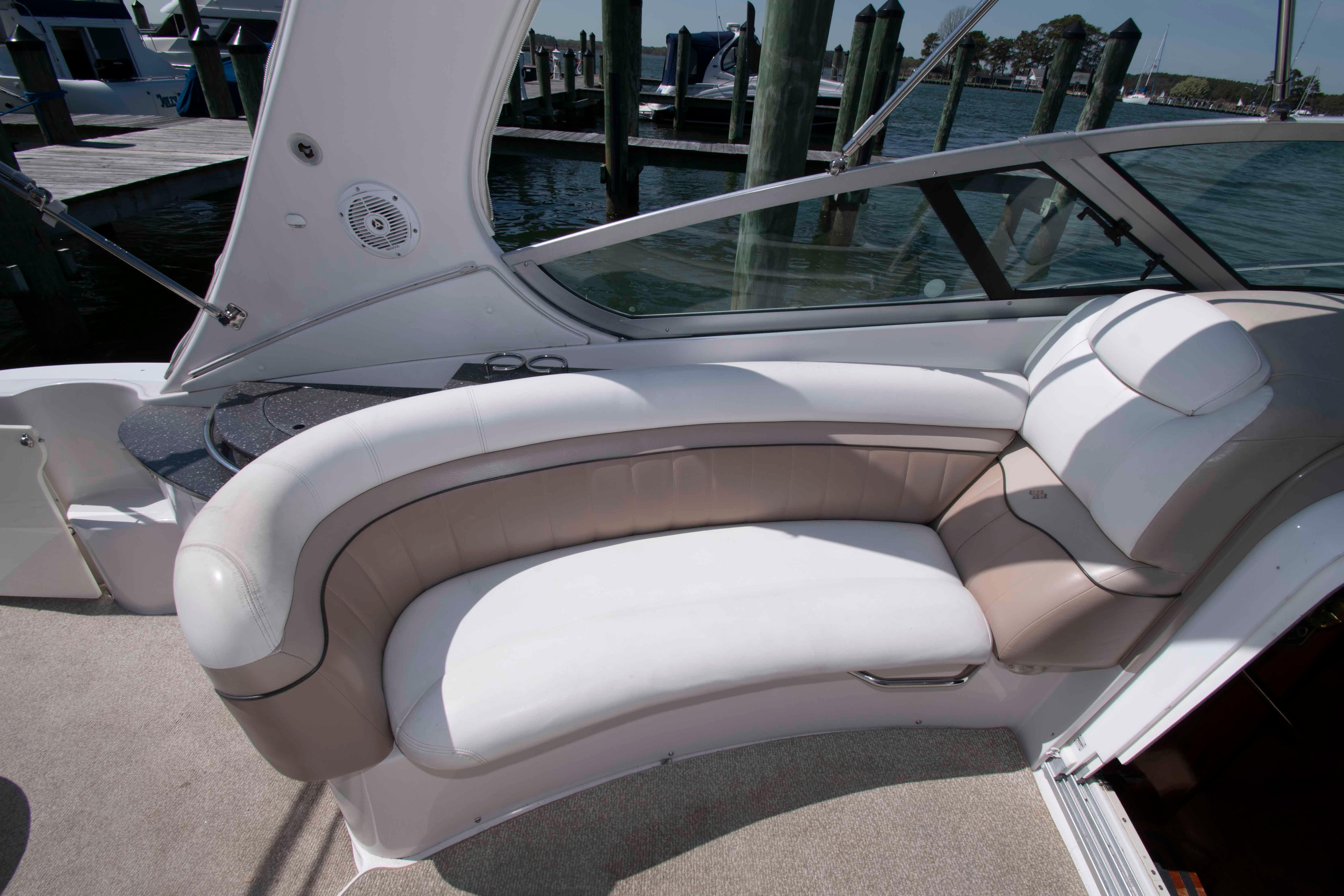 Luxurious seating area on a 2007 Four Winns 358 Vista boat docked by the water.