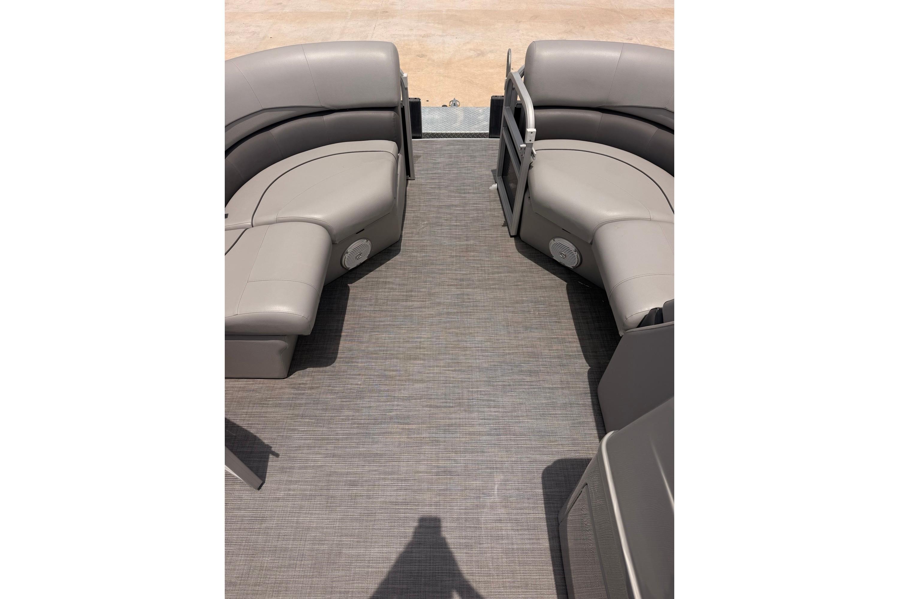 Interior view of 2021 Lowe SS 210 pontoon boat with gray seating and flooring.