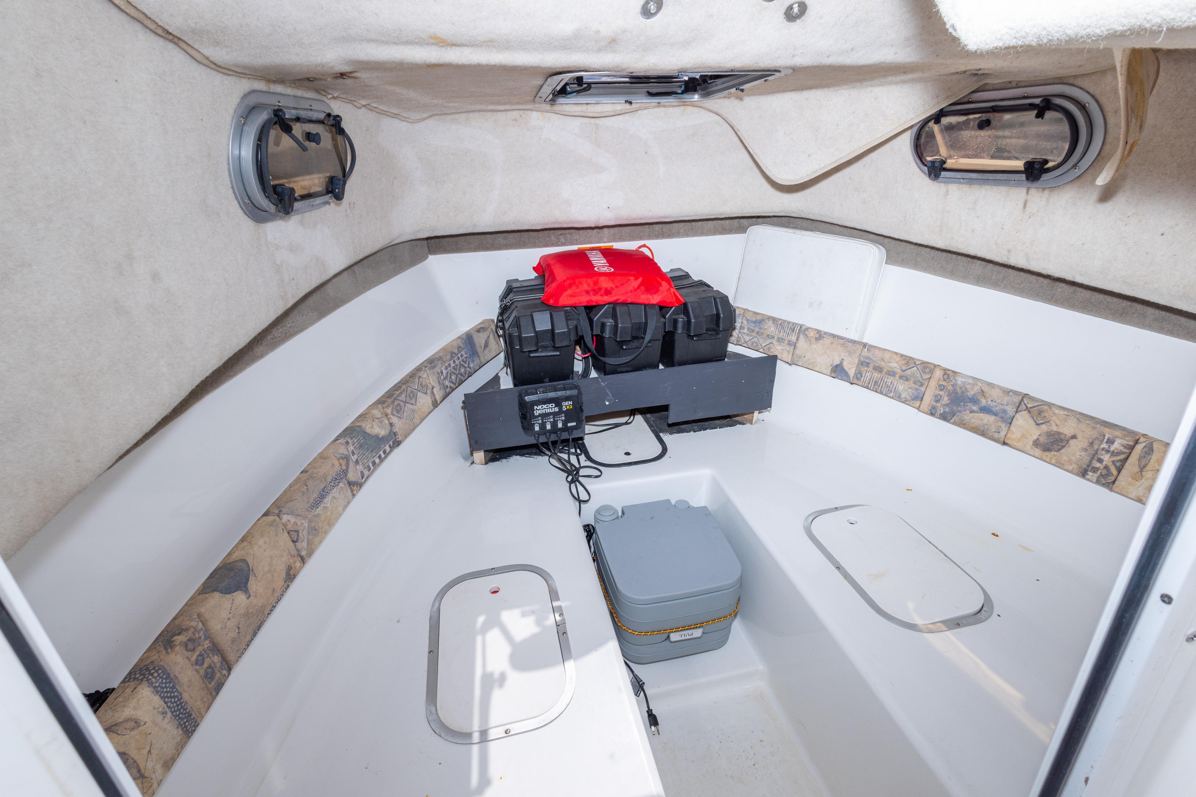2007 Sea Boss 235 Walkaround cabin interior with storage and equipment.