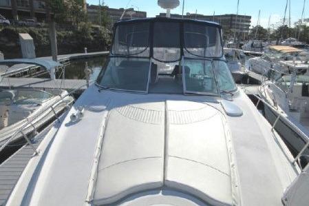 2005 Cruisers Yachts 370 Express docked at marina, front deck view.