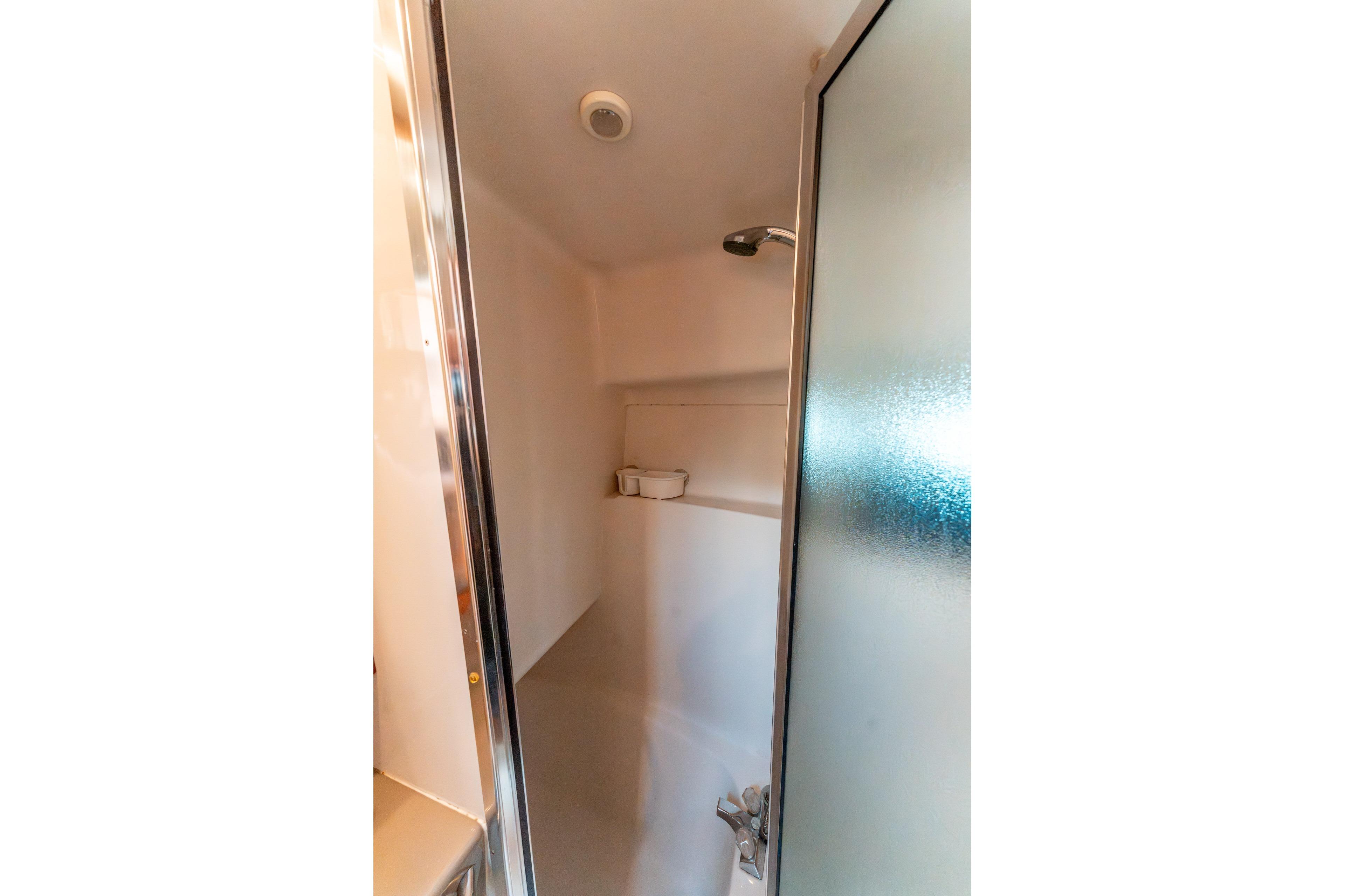 Shower area in 1997 Bayliner 3788 Command Bridge Motoryacht with frosted glass door.