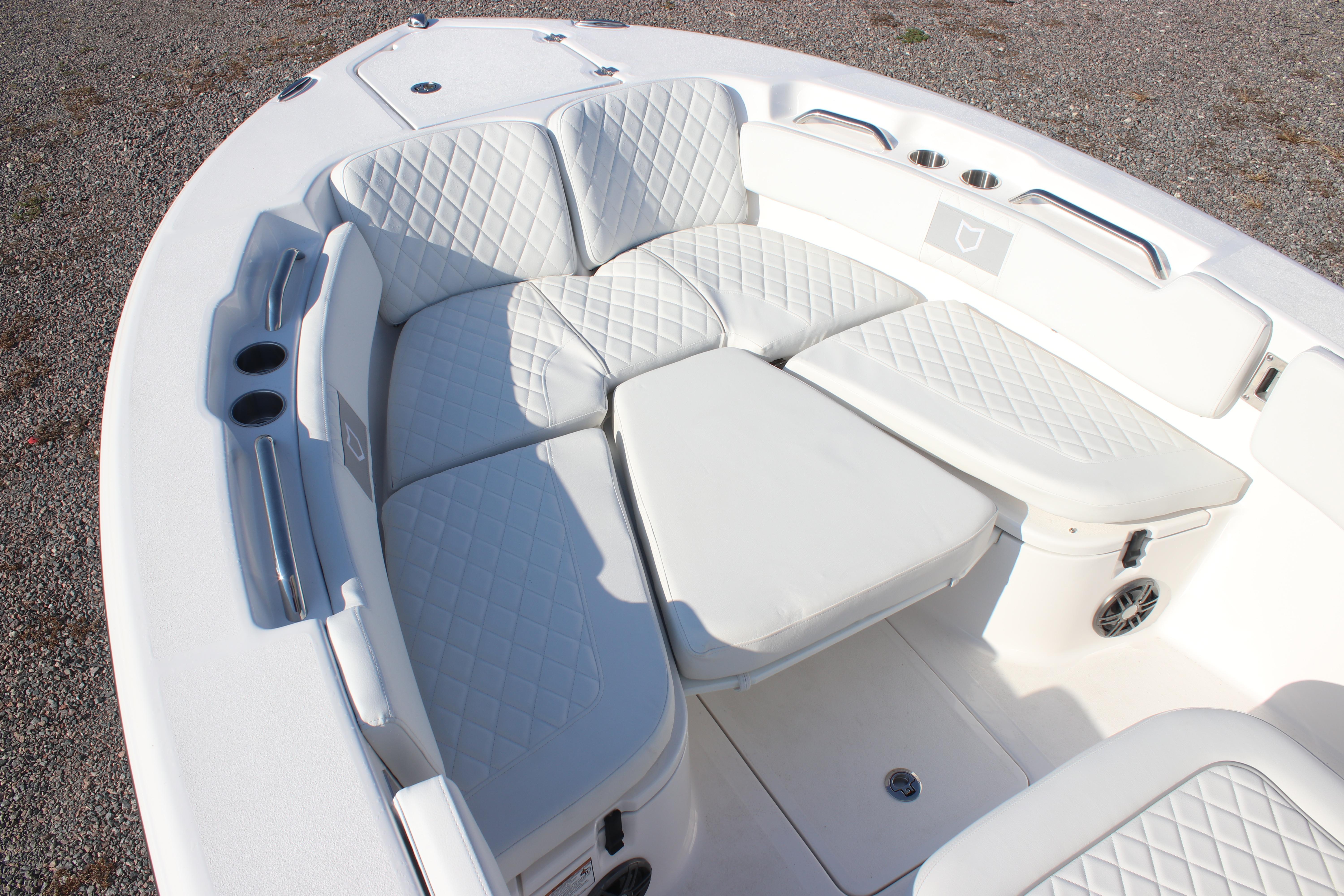 2026 Sea Fox 248 Commander boat with white cushioned seating and cup holders.