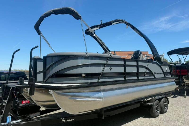 2026 Berkshire STS 23 Ultra Lounger SportArch pontoon boat on trailer, sunny day.