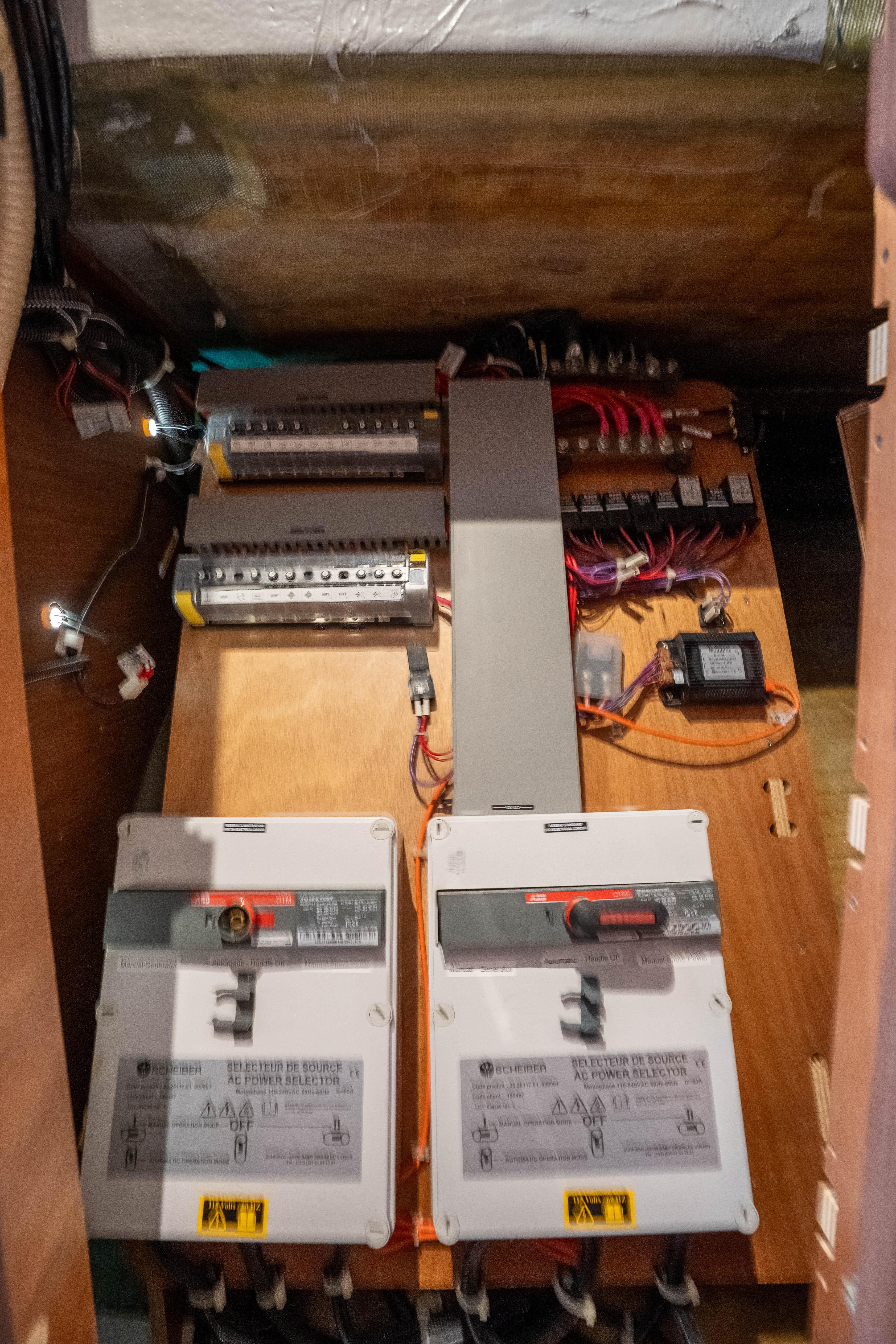 Electrical panel inside a 2022 Lagoon 46 yacht, showcasing circuit breakers and wiring.