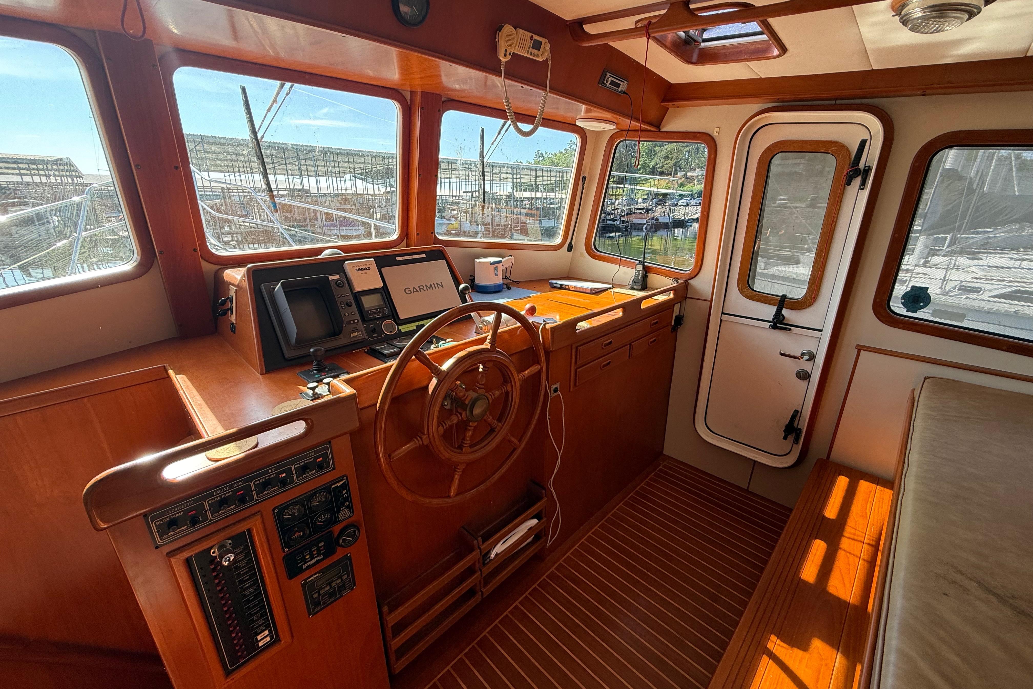 Interior of 2001 Kadey-Krogen 39 boat with wooden helm and navigation equipment.