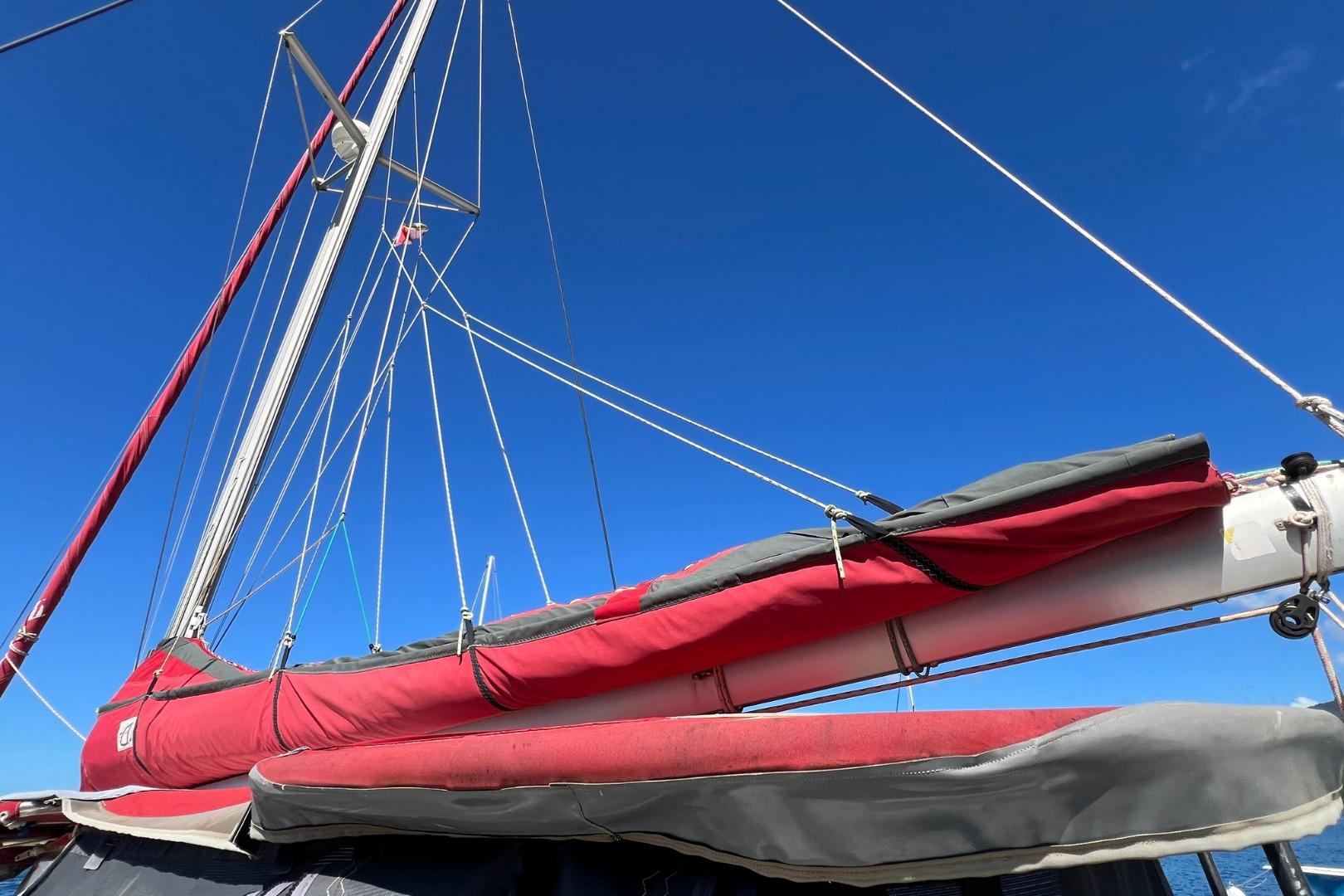 2001 Lagoon 380 sailboat mast and rigging against clear blue sky.