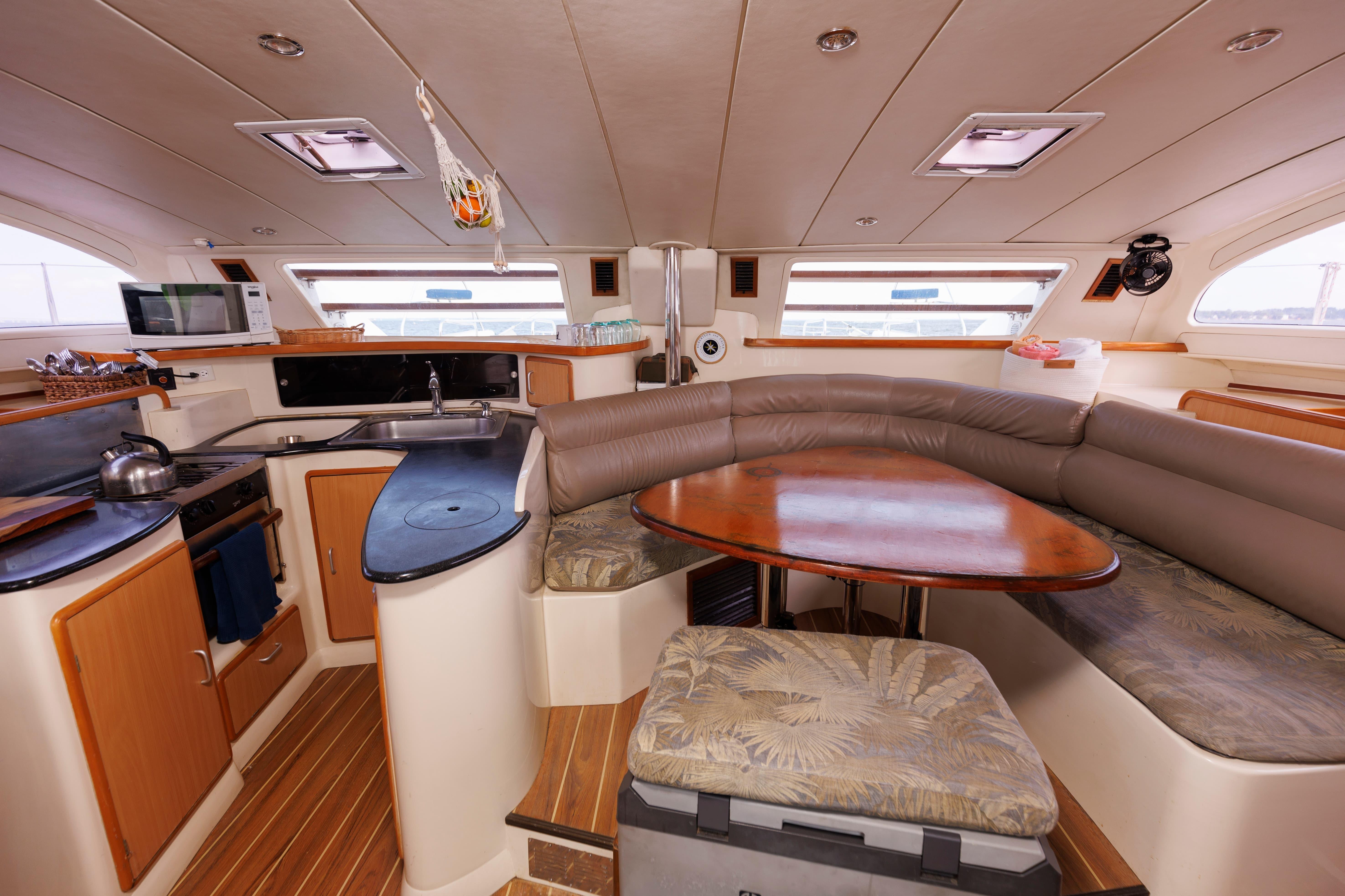 Luxurious interior of a 2006 Leopard 43 yacht with kitchen and dining area.