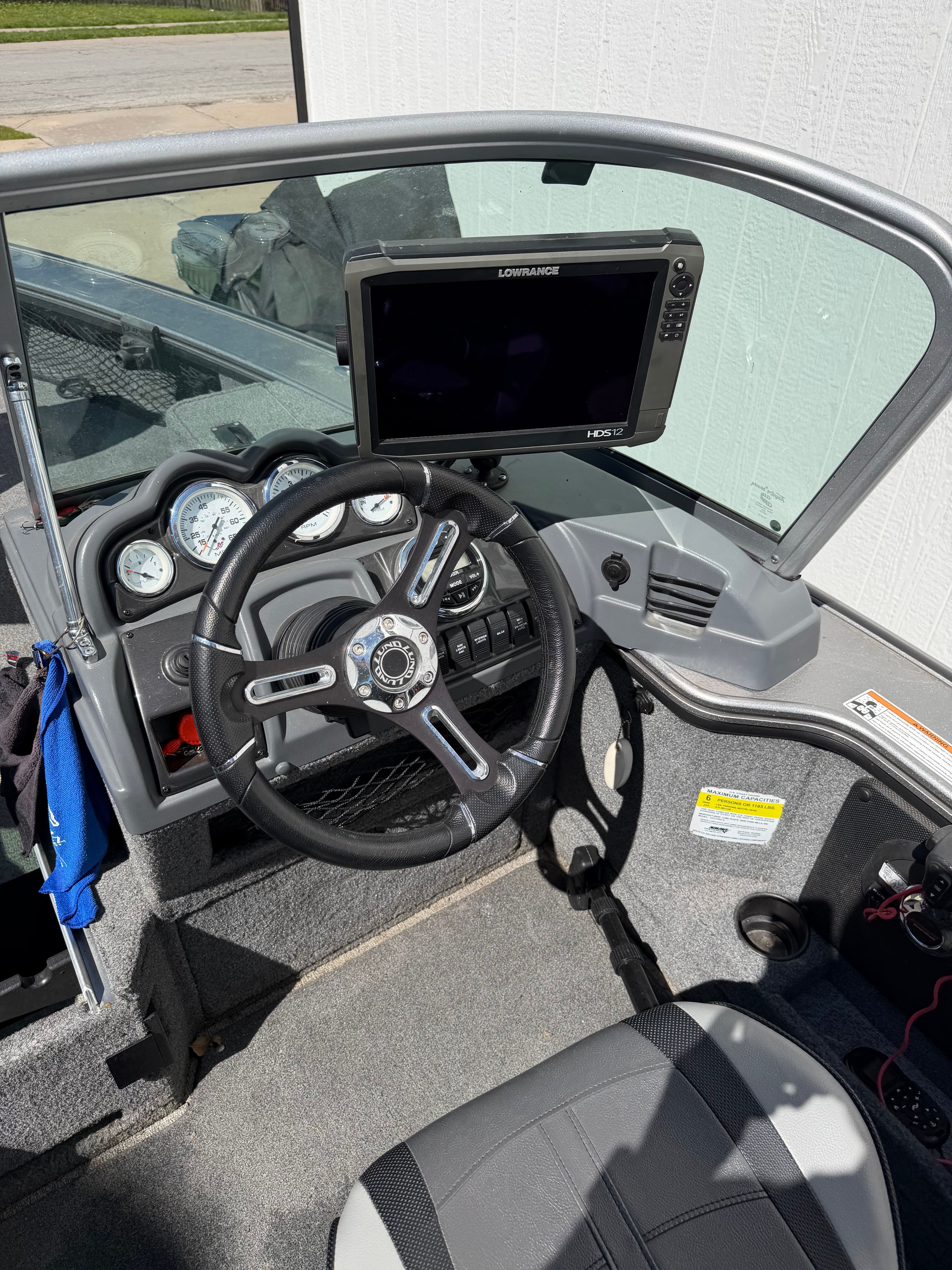 Interior view of a 2017 Lund Pro V 1975 boat with steering controls.