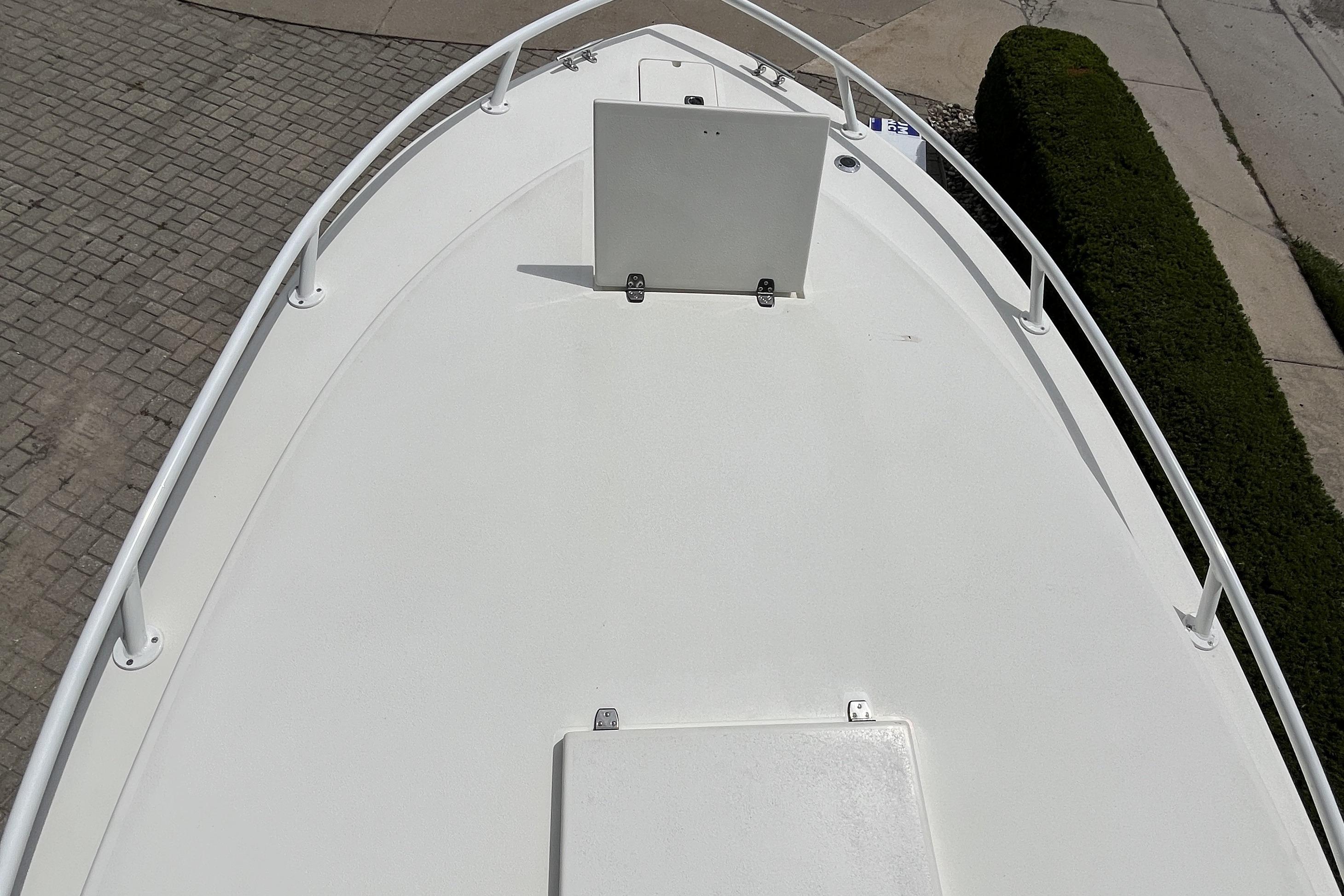 Bow view of a 1994 Intrepid 30 Open Cuddy boat, featuring a clean white deck.
