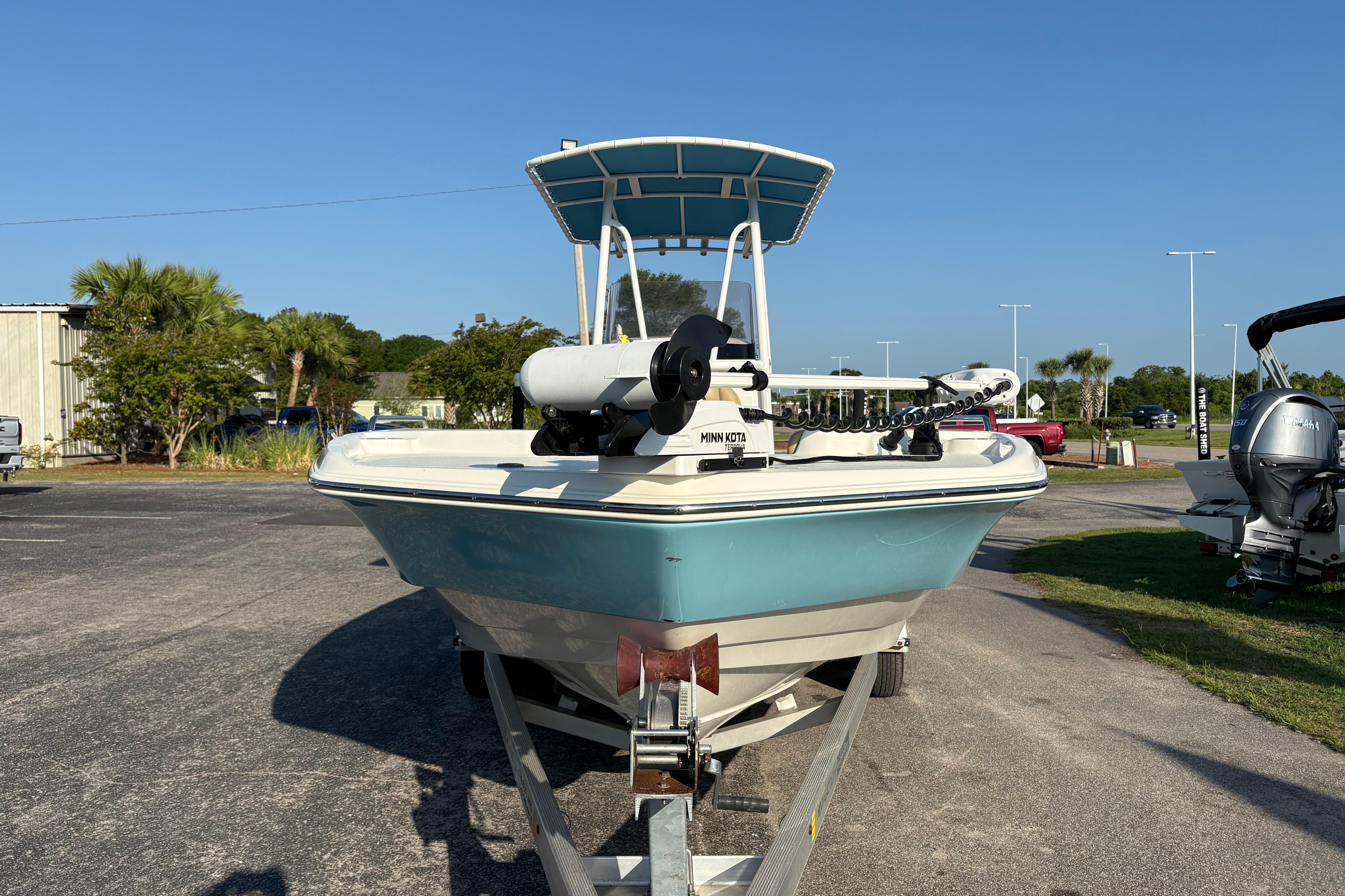 2019 NauticStar 231 Hybrid boat on trailer, parked outdoors under clear blue sky.