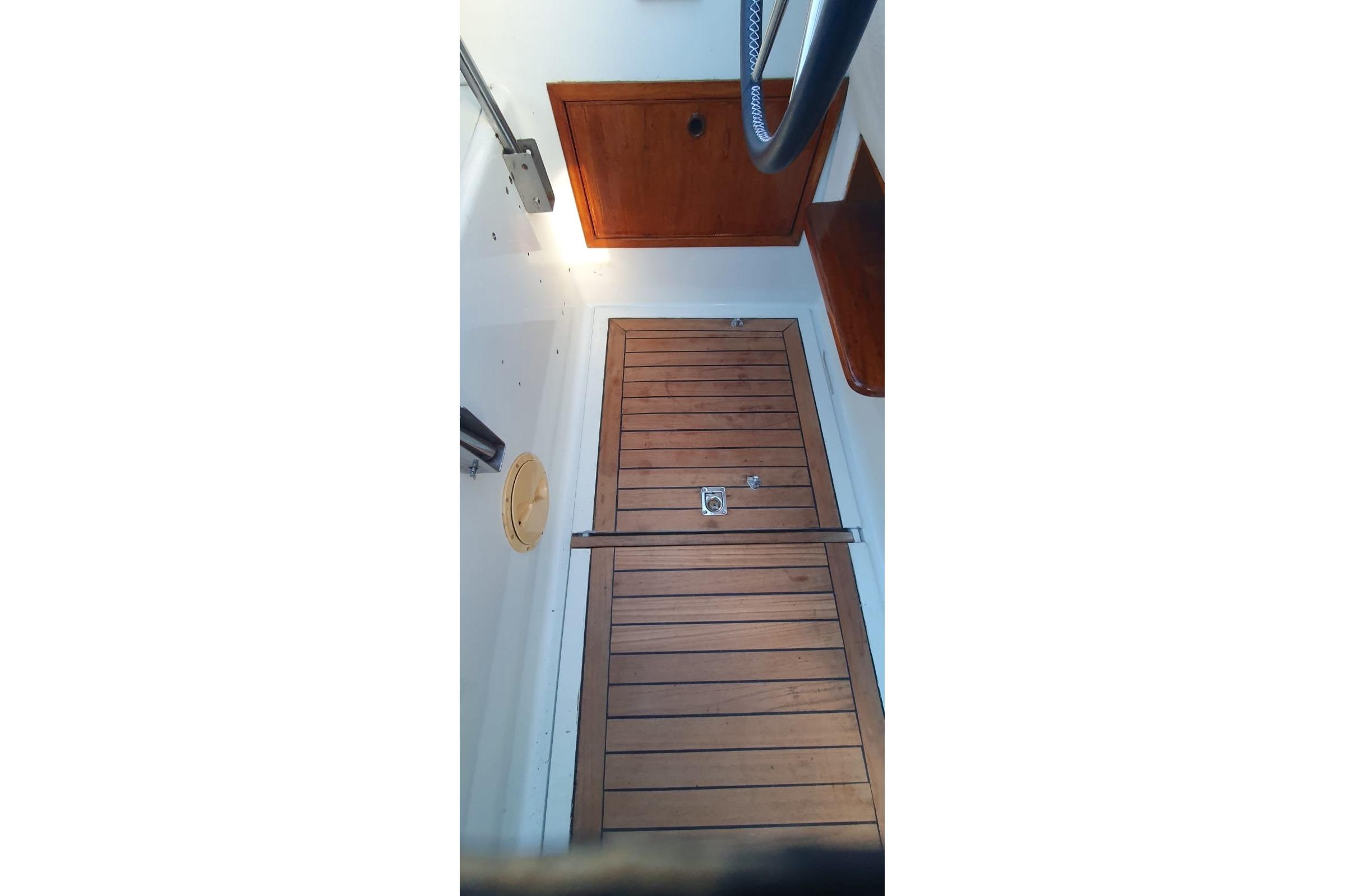 Wooden cabin door inside 1989 Fairey Spearfish MKIII boat, featuring sleek design and nautical elements.