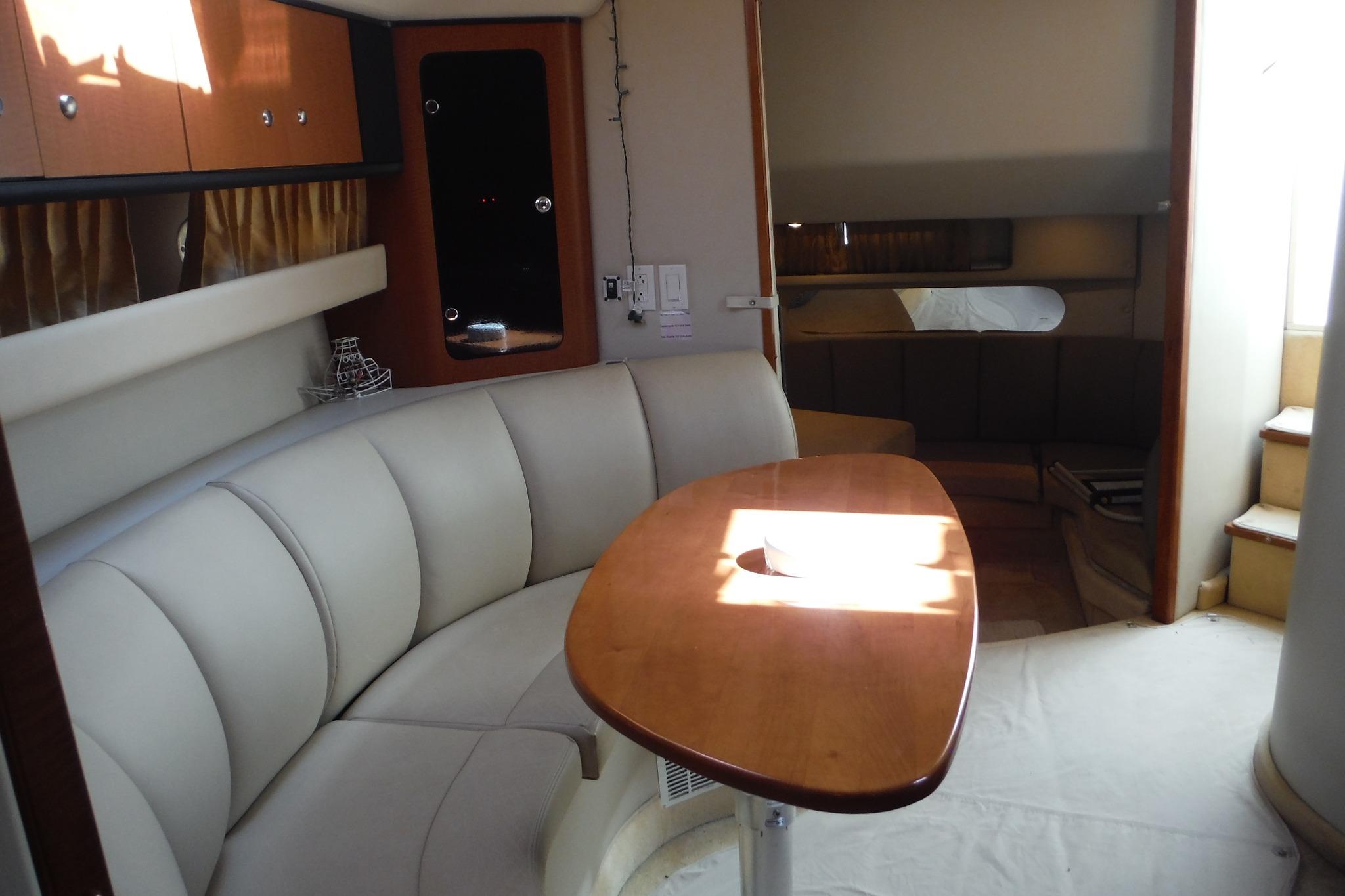 Interior of 2005 Chaparral Signature 350 yacht with elegant seating and wooden table.