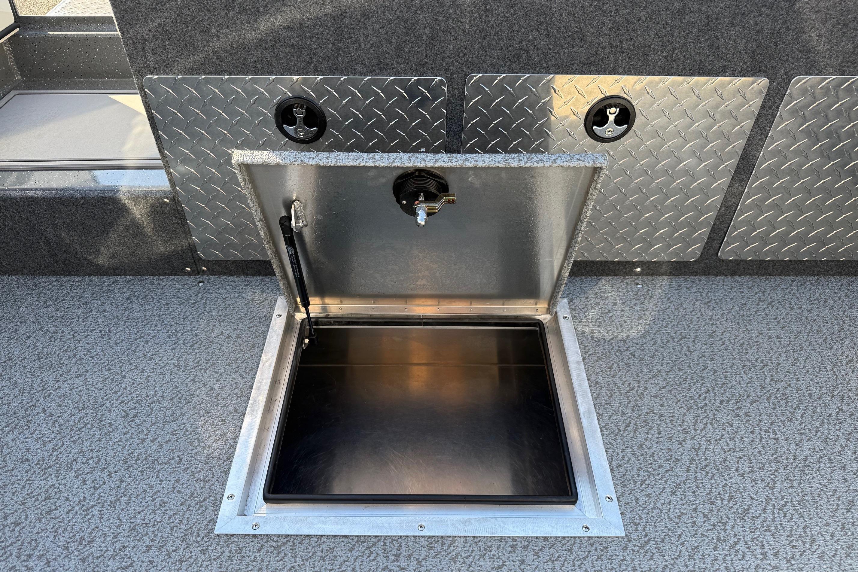 Open storage compartment on 2026 Thunder Jet 185 Luxor boat with diamond plate detailing.