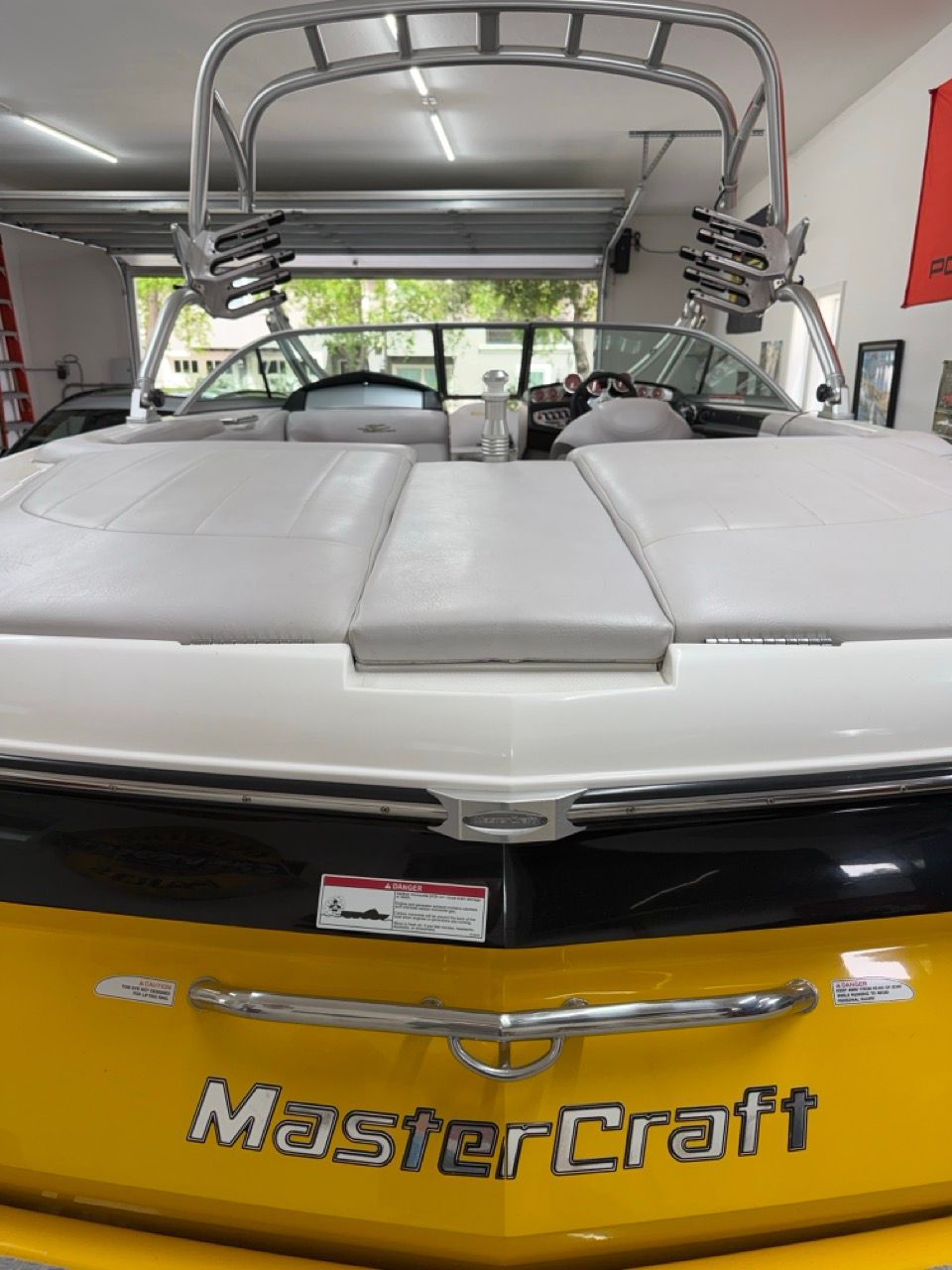 2006 MasterCraft X30 with a yellow hull and white upholstery in the interior.