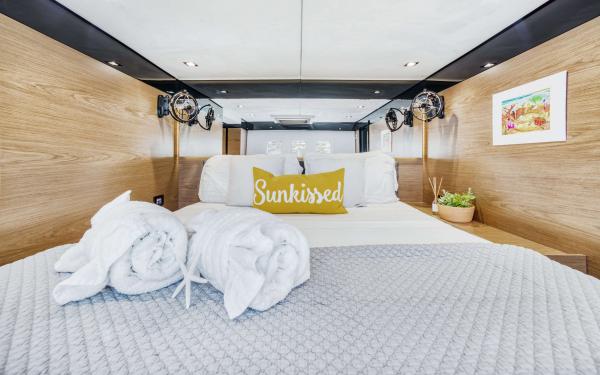 Luxurious Sunreef 60 LOFT 2016 yacht bedroom with cozy bedding and elegant decor.