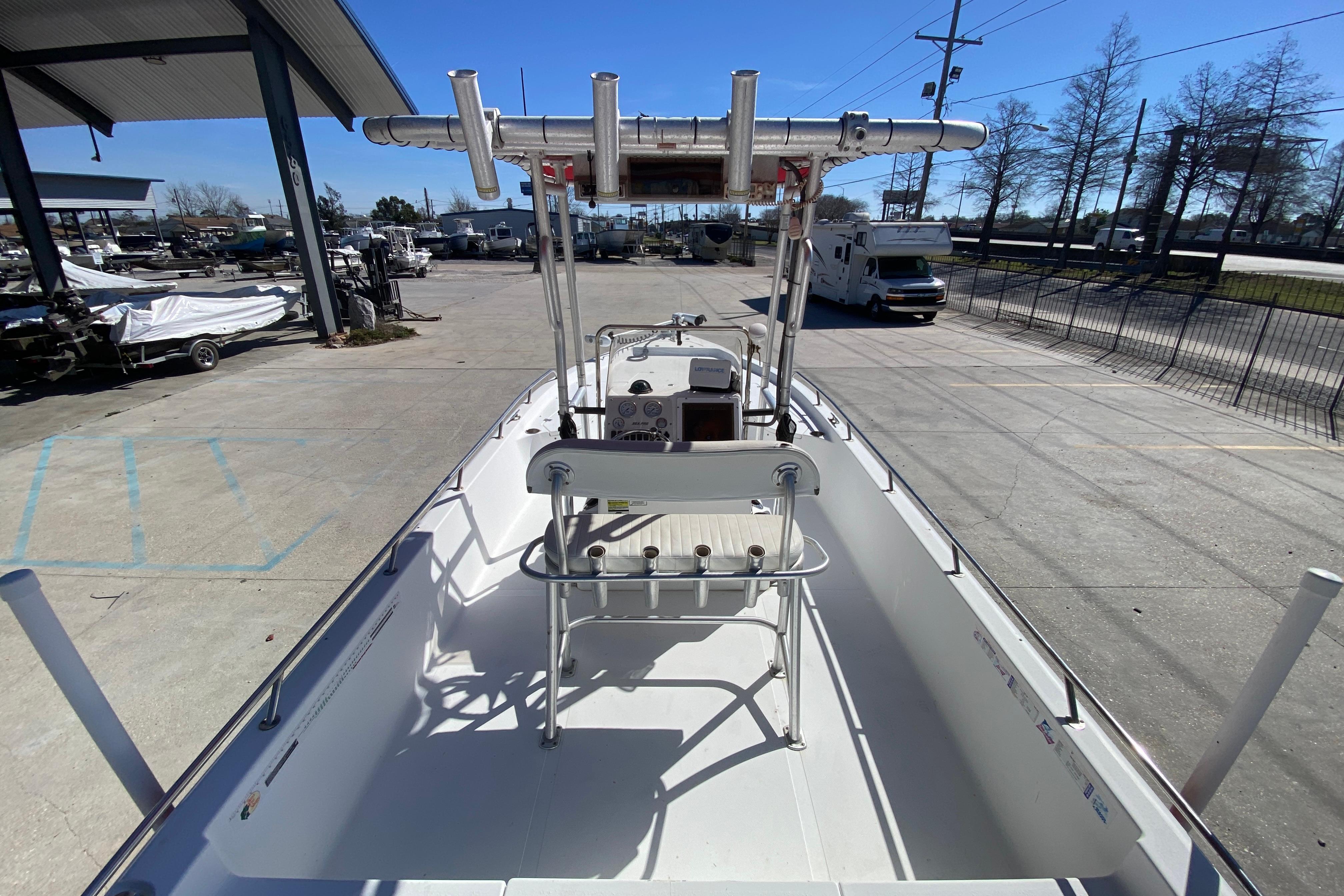 2005 Sea Pro SV2400CC Bay Boat, docked, showcasing spacious deck and T-top.