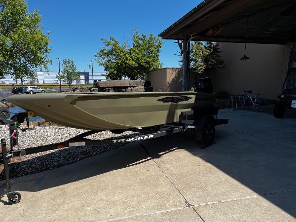 2025 Tracker Grizzly 1650 T Prairie Wings Edition boat on trailer, parked outdoors.