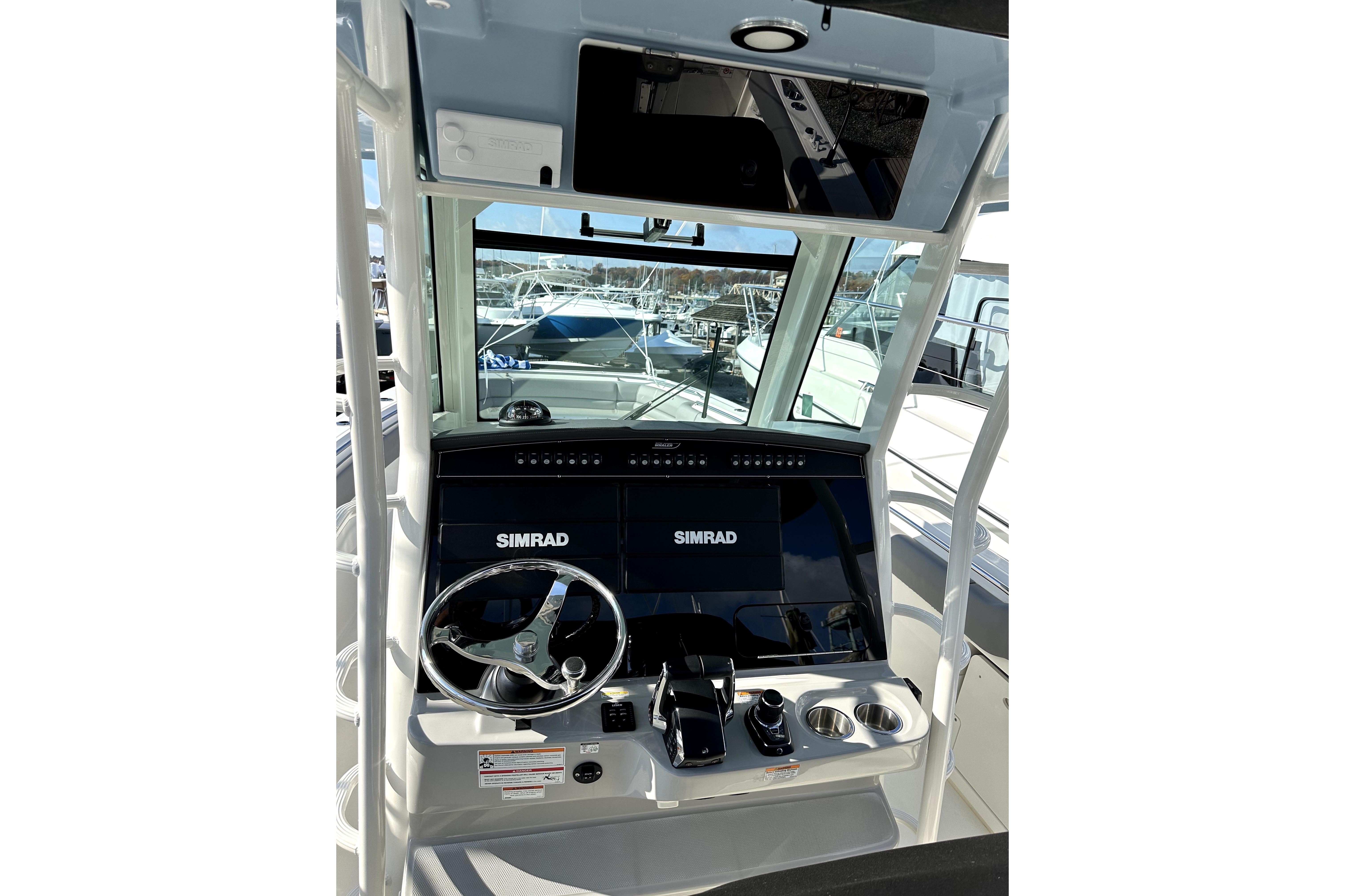 2023 Boston Whaler OUTRAGE boat dashboard with Simrad navigation system.
