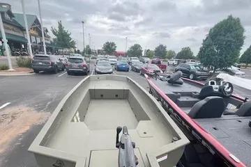 2026 Tracker Grizzly 1650 T Prairie Wings Edition boat in parking lot.