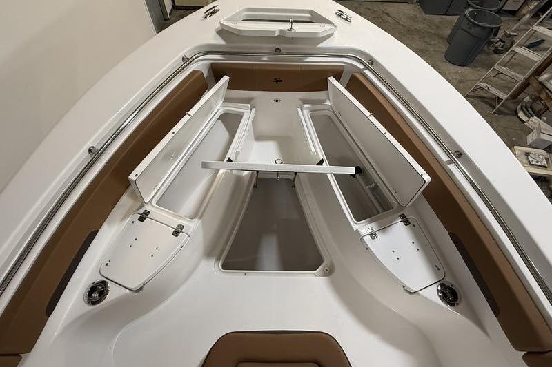 2026 Sea Pro 242 Center Console boat with open storage compartments and sleek design.