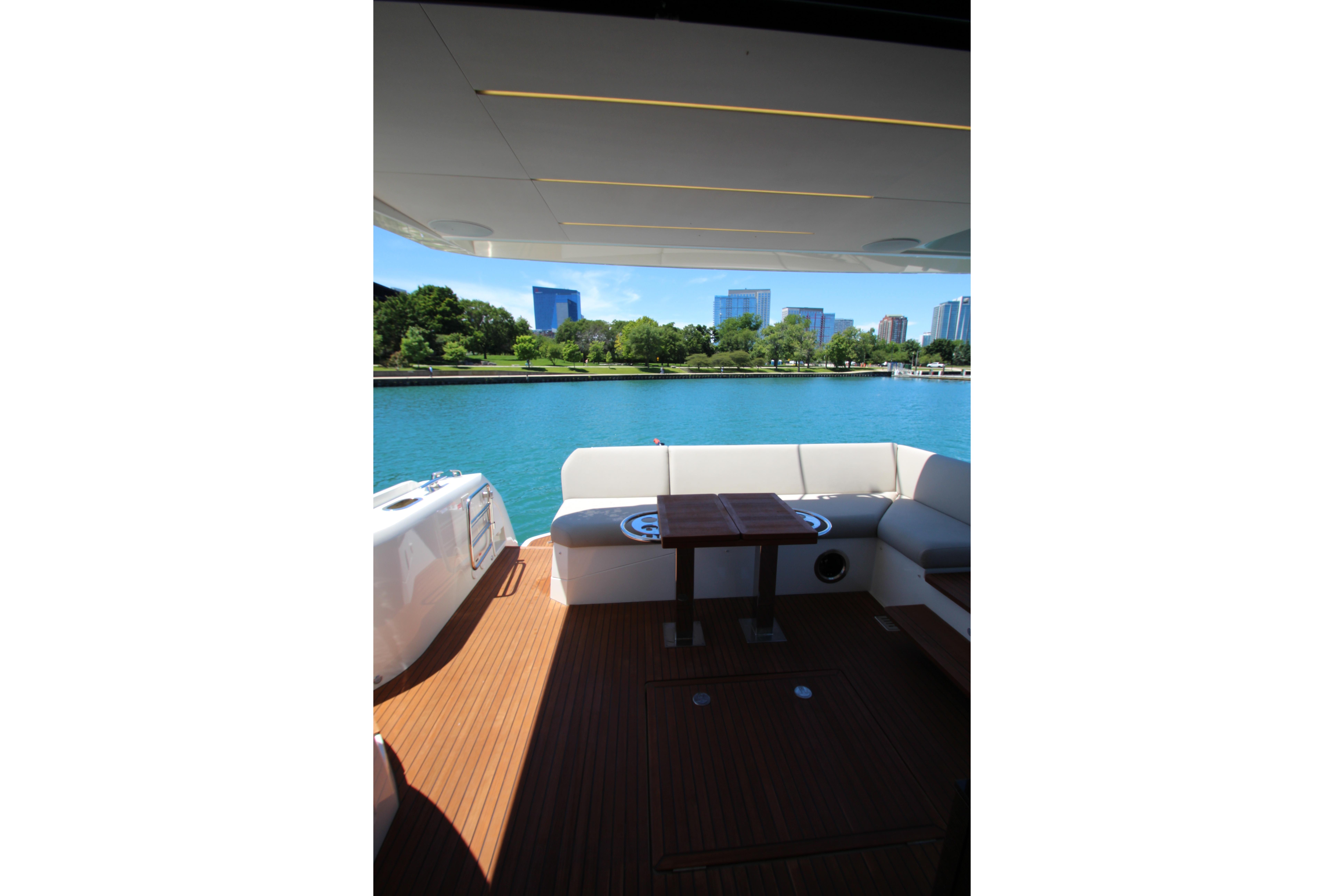 Luxurious 2022 Prestige 520 yacht interior with waterfront cityscape view.