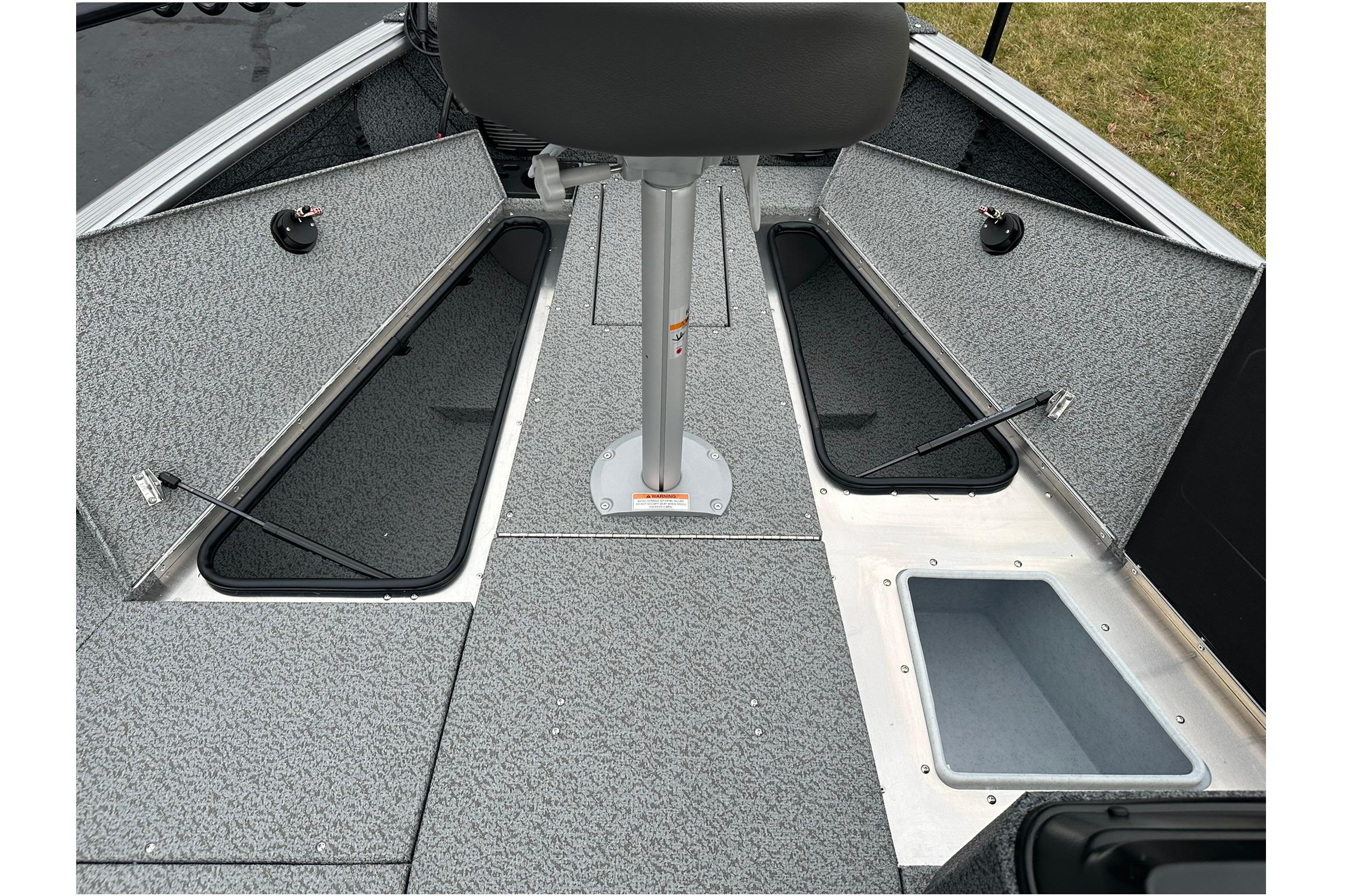 2026 Lund 1875 Impact XS SS boat interior with open storage compartments.