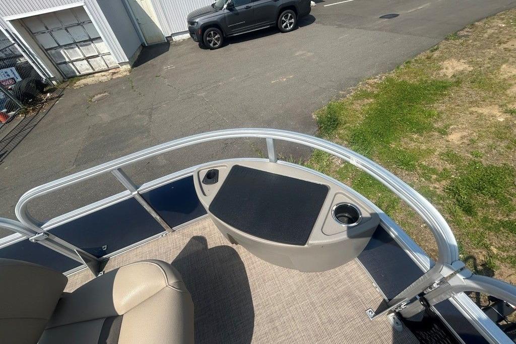 2023 Sun Tracker Bass Buggy 18 DLX pontoon boat deck with seating and cup holders.