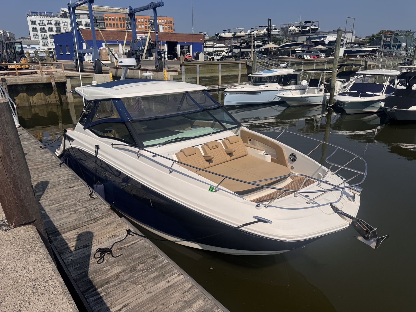 A 2019 Sea Ray Sundancer 320 docked. It features a sleek design with a spacious deck.