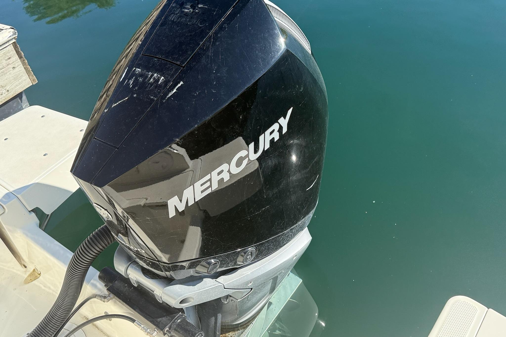 Mercury outboard motor on 2024 Bayliner Trophy T25 Pilothouse, docked on calm water.