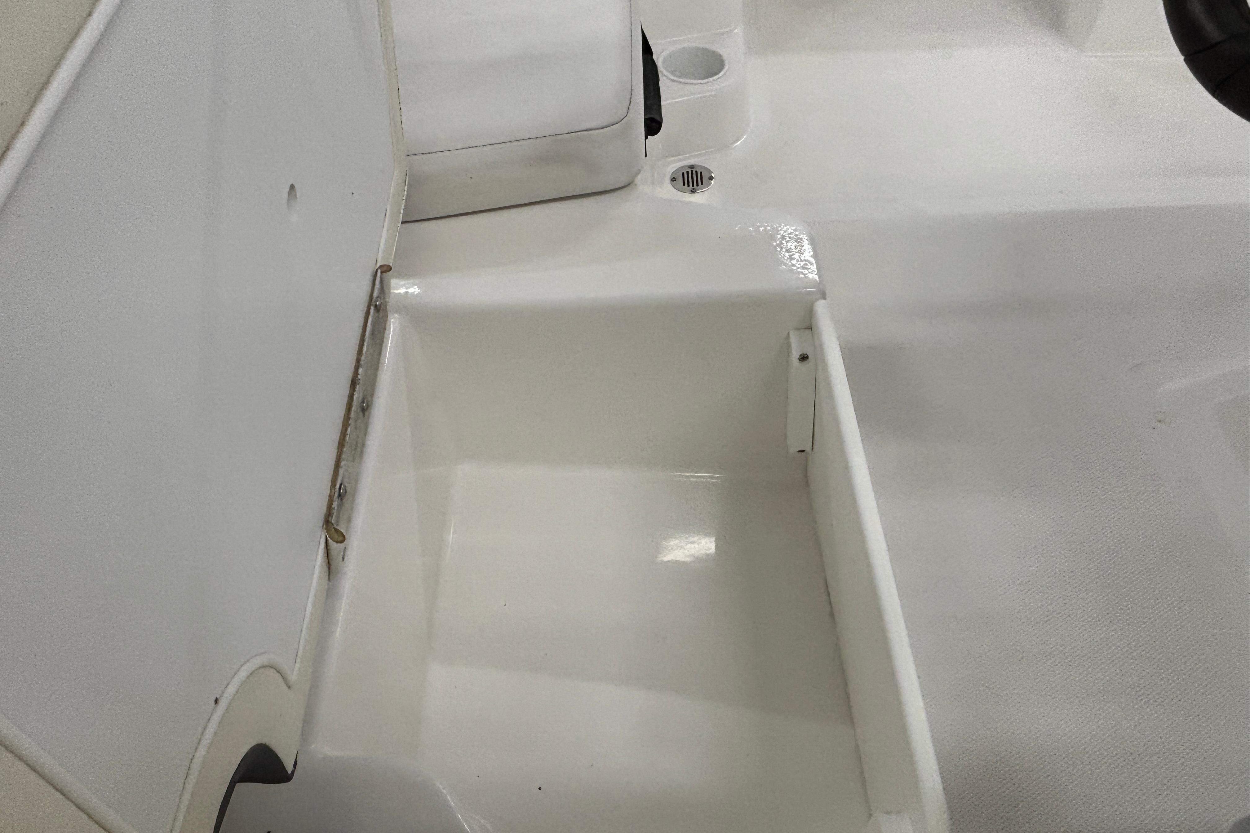 2024 Tahoe T18 boat interior storage compartment with open lid.