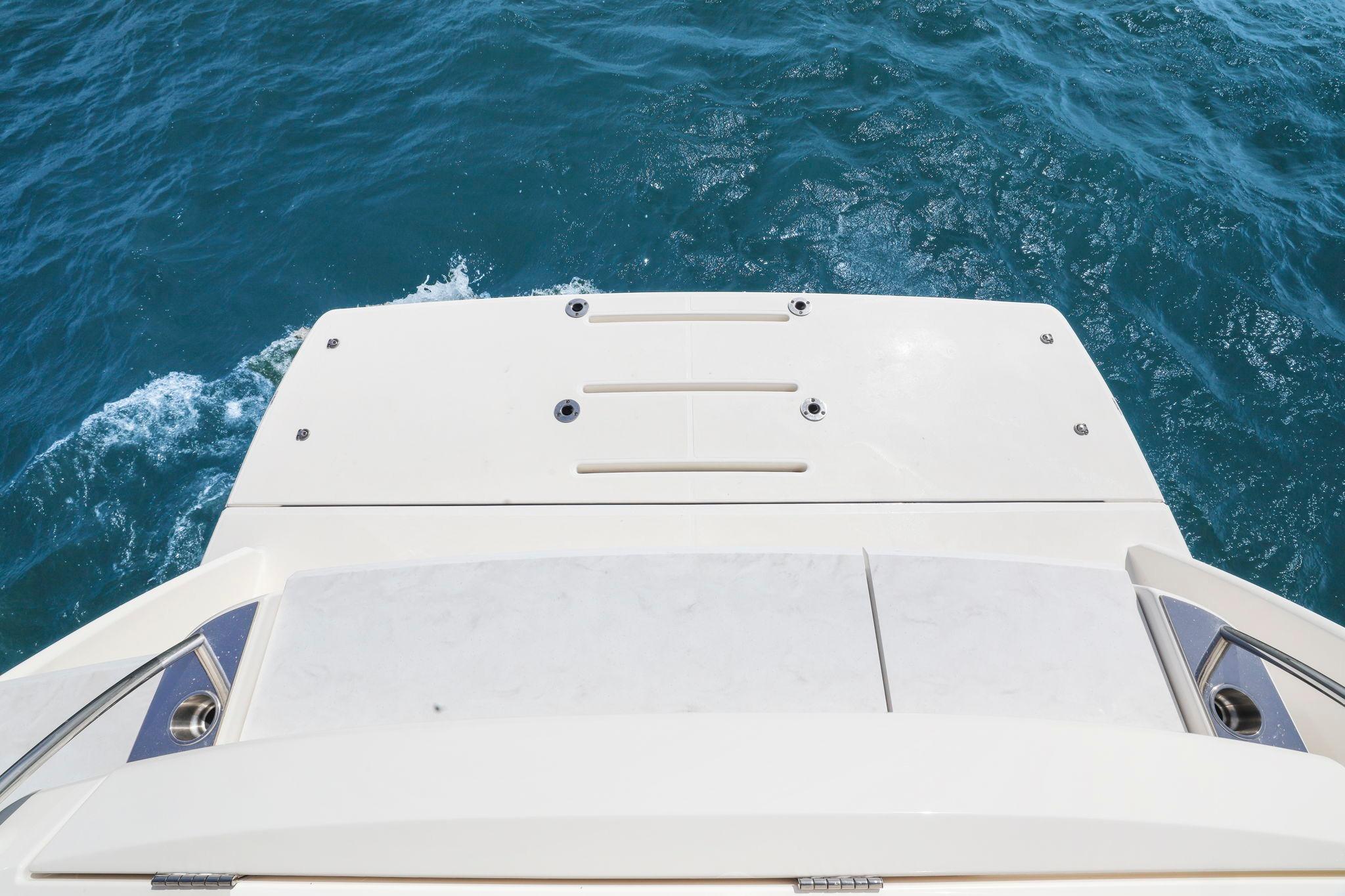 2023 Tiara Yachts C49 Coupe swim platform on blue ocean water.