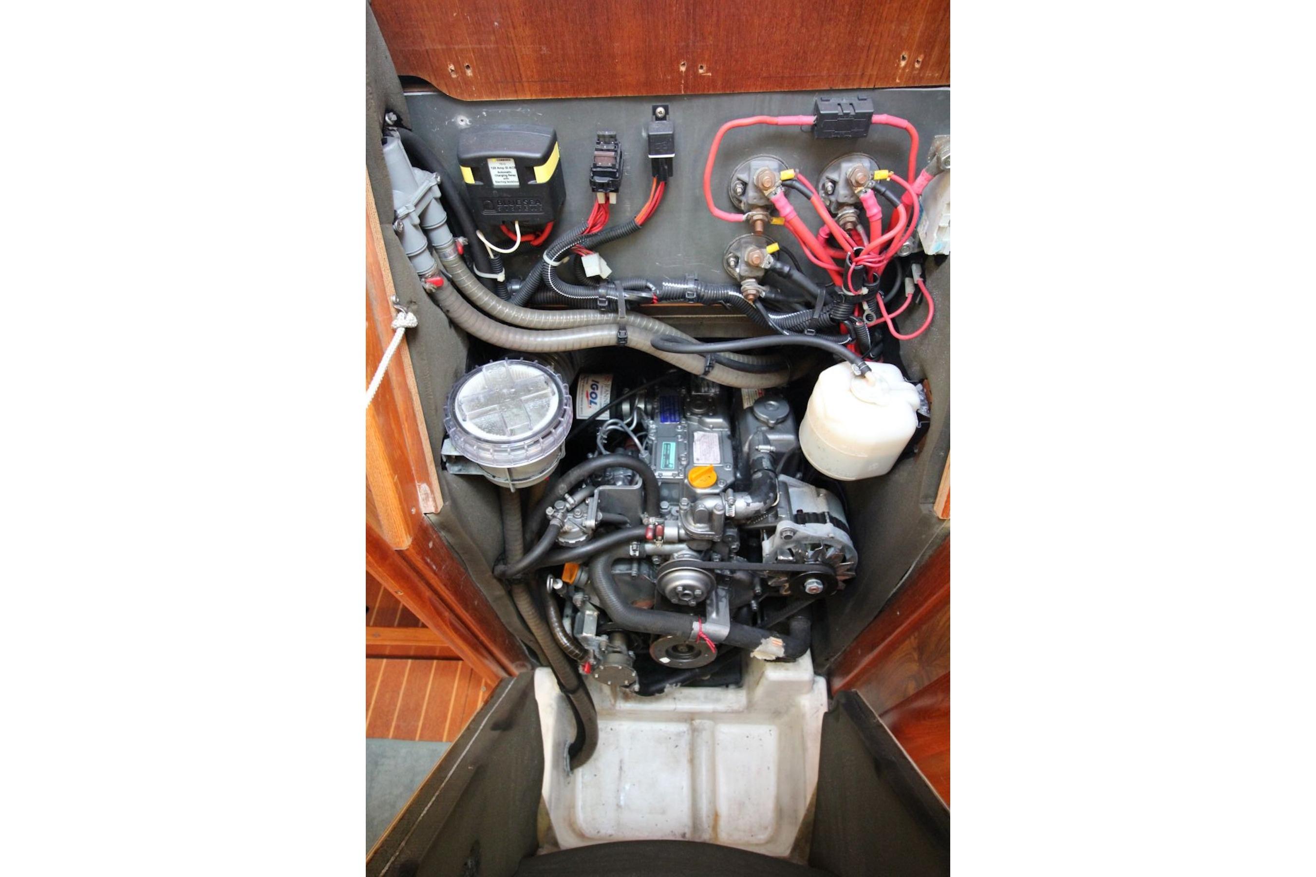 Engine compartment of a 2004 Jeanneau Sun Odyssey 35 sailboat, showcasing wiring and components.