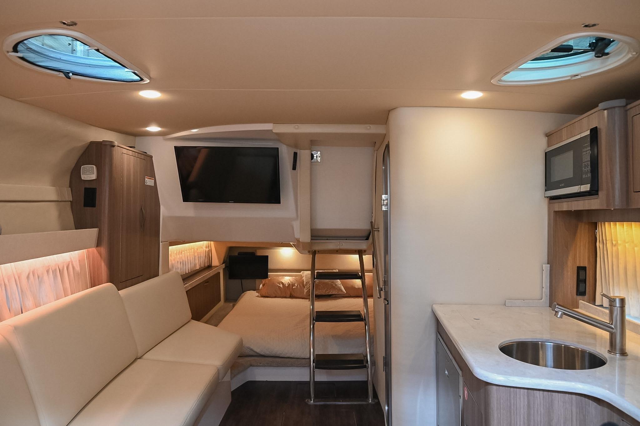 Interior of a 2021 Regal 33 Express yacht with modern amenities and cozy seating.