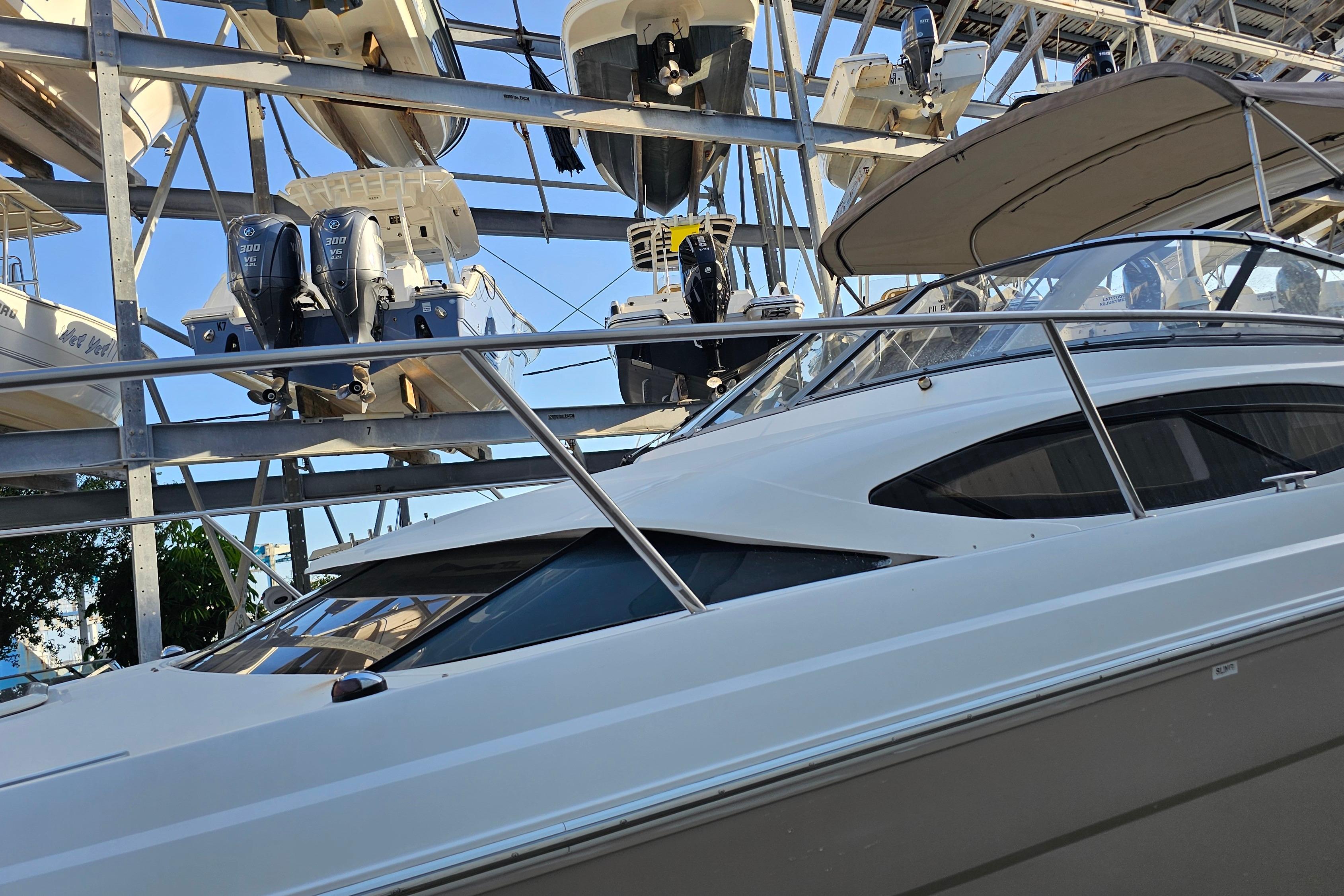 2005 Regal 3060 Window Express boat in storage, surrounded by other vessels.