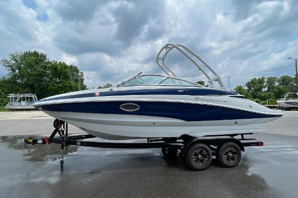 2023 Crownline E235 boat on trailer under cloudy sky.