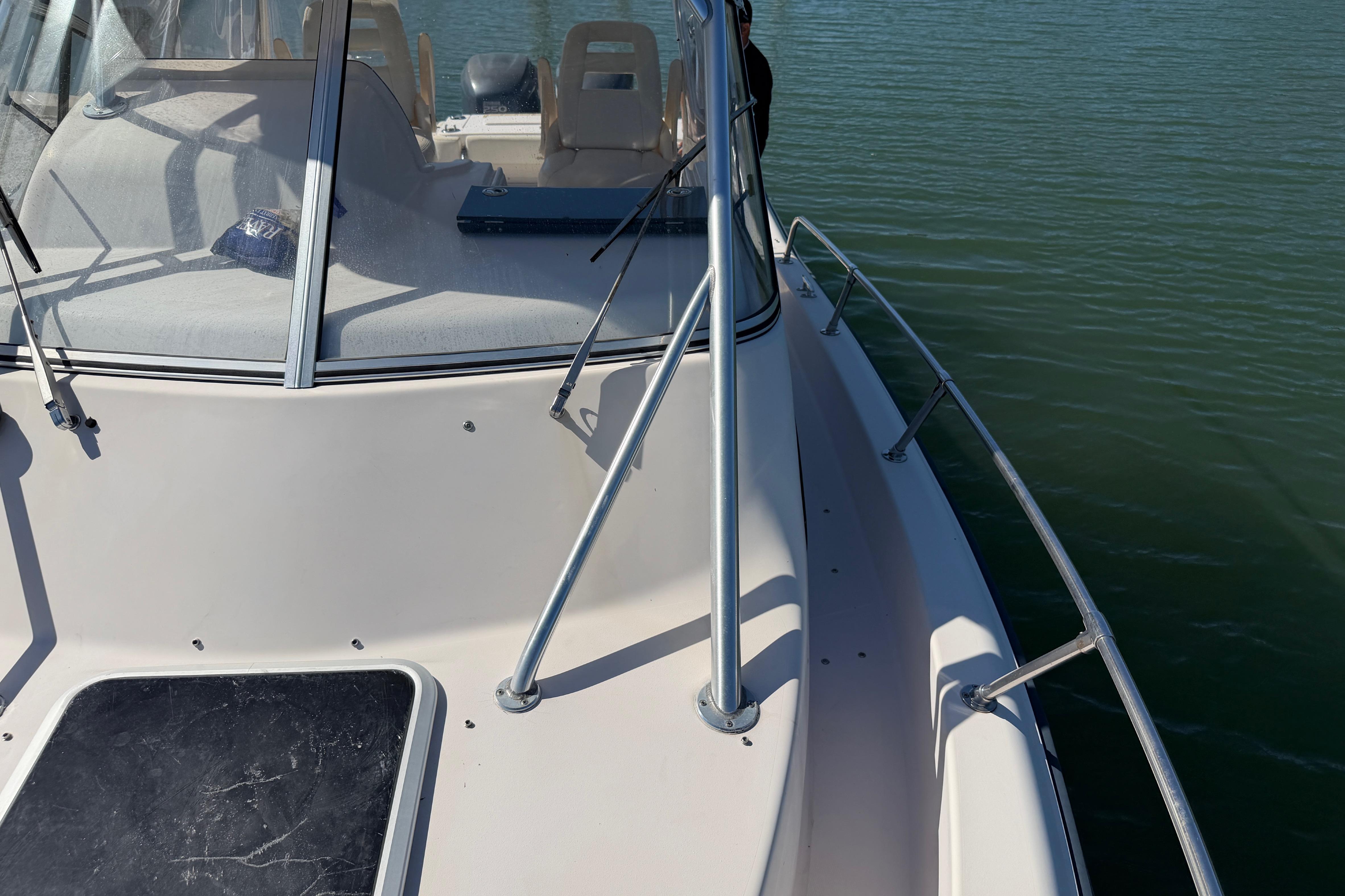 2006 Grady-White Sailfish 282 boat deck with windshield and railing on water.