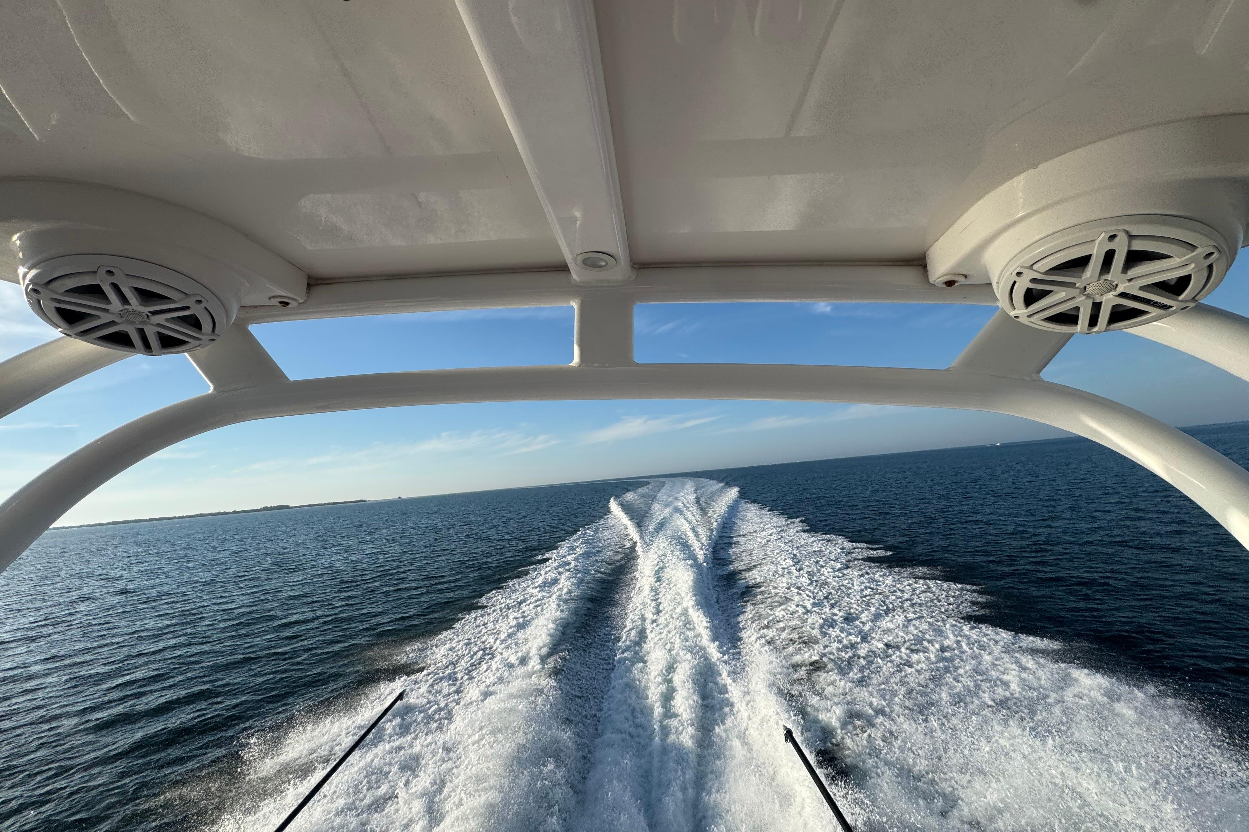 2019 Scout 420 LXF boat cruising on open water, leaving a wake trail.