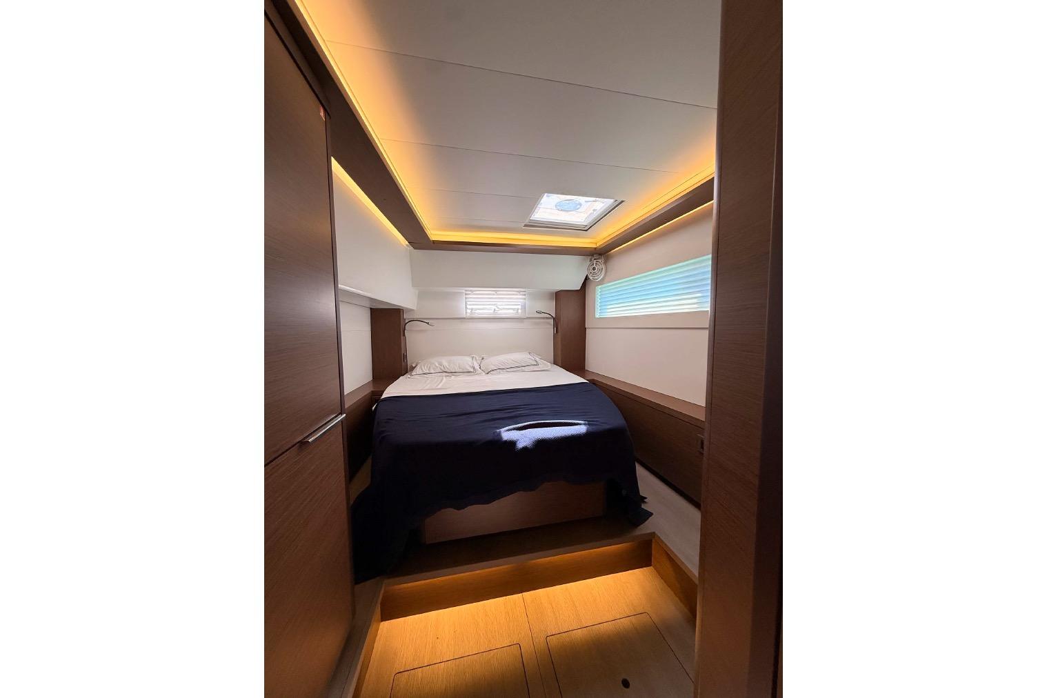 Luxurious cabin interior of 2020 Lagoon 46 yacht with modern lighting and cozy bed.