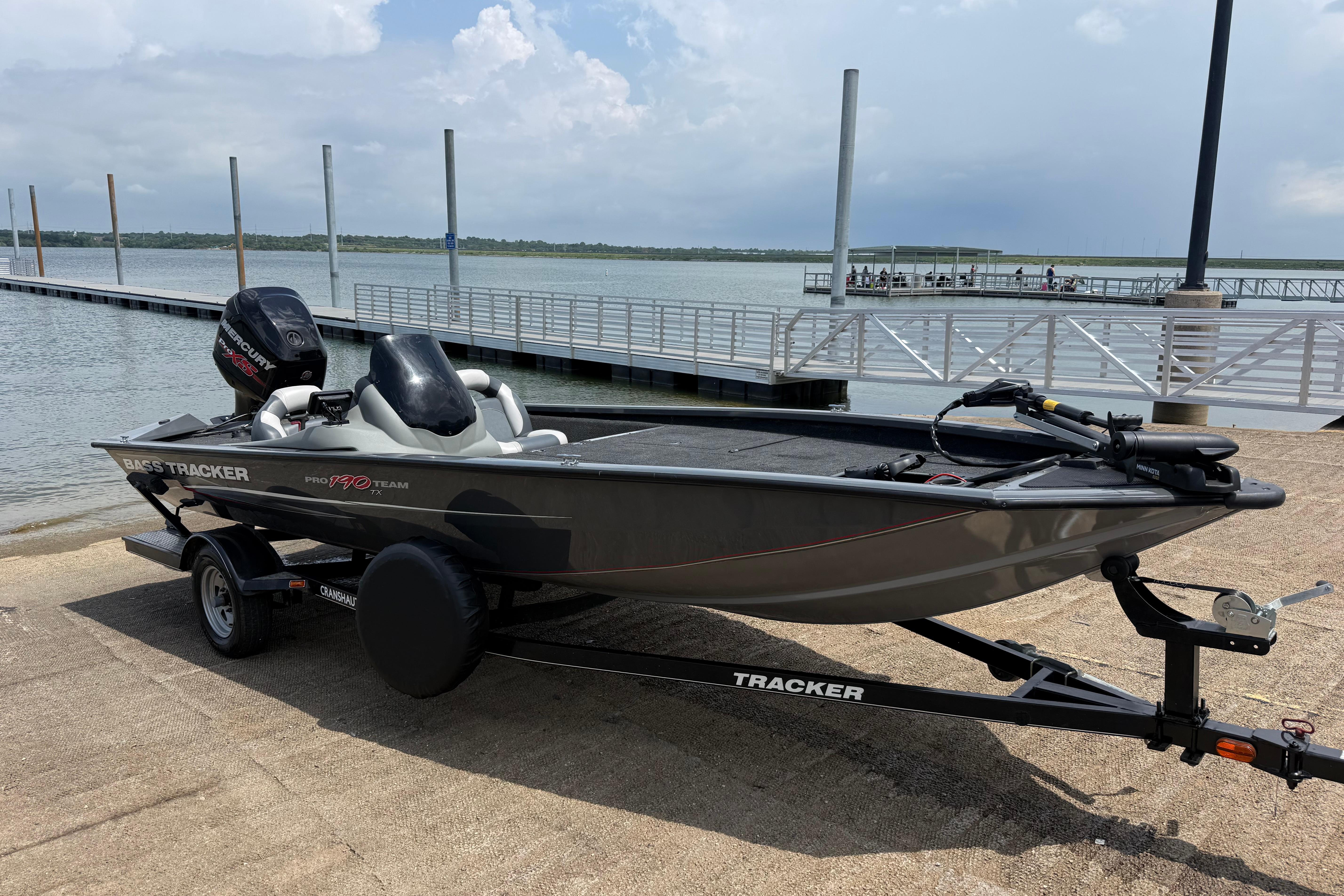 2015 Tracker Pro Team 190 TX boat on trailer by a lakeside dock.