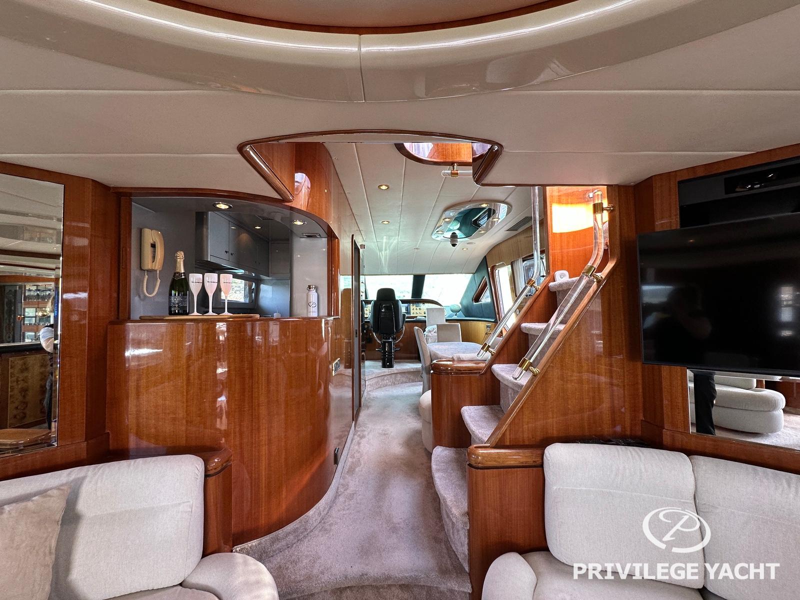 Luxurious interior of 2003 Elegance 76 yacht with polished wood and modern amenities.