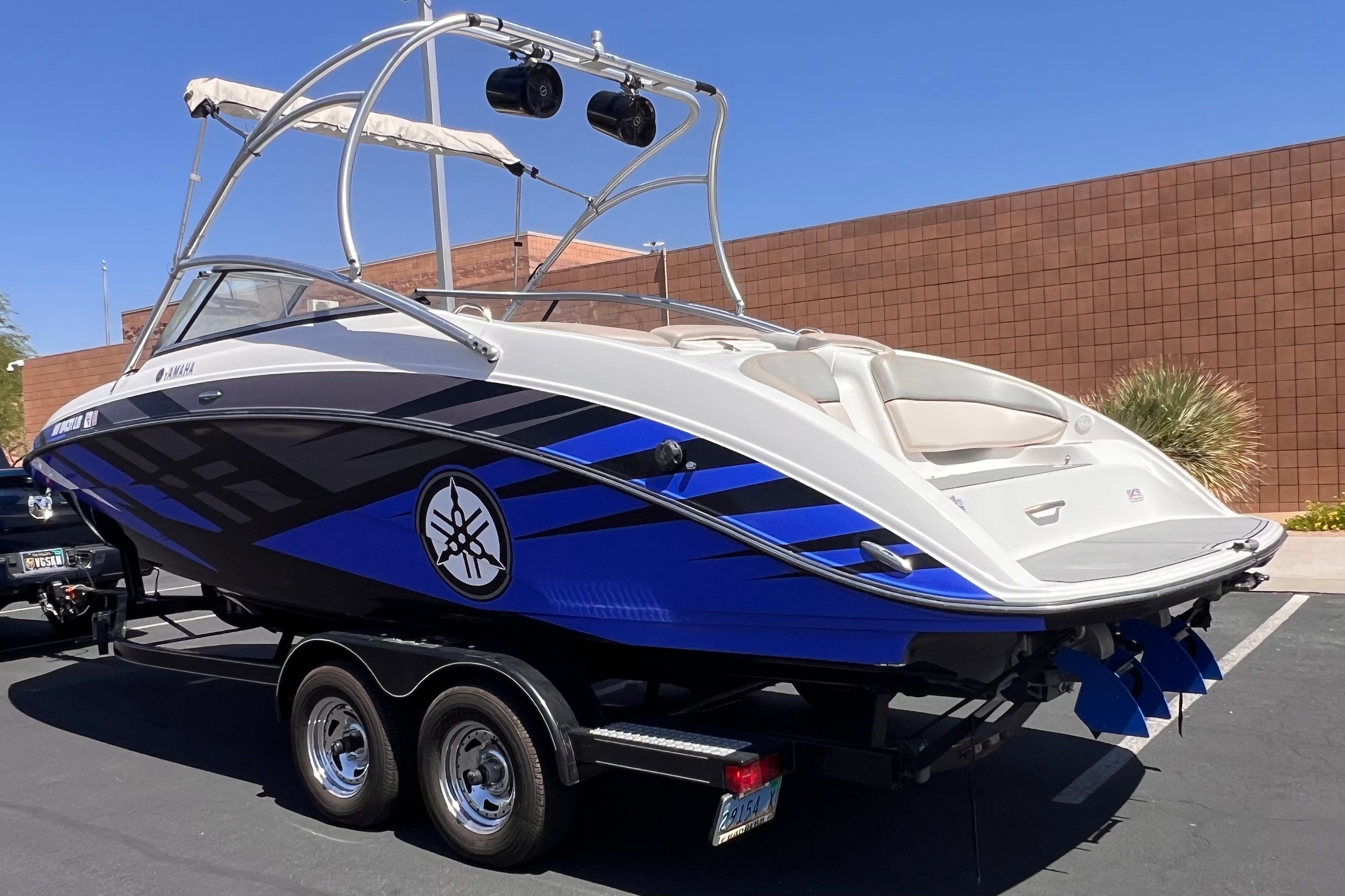 2011 Yamaha AR240 HO boat on trailer, blue and white design.