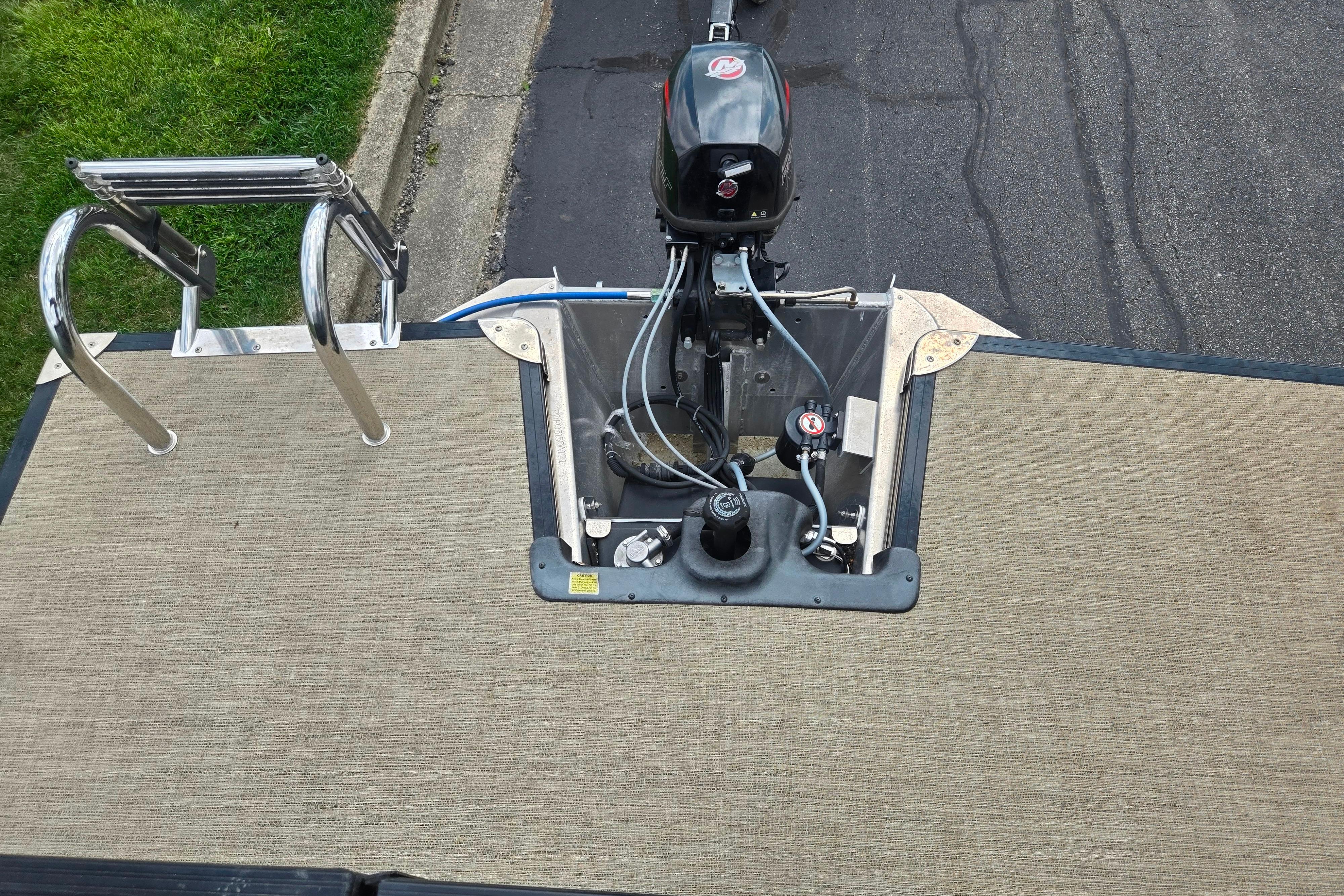 2021 Barletta C22QC boat stern with motor and swim ladder.