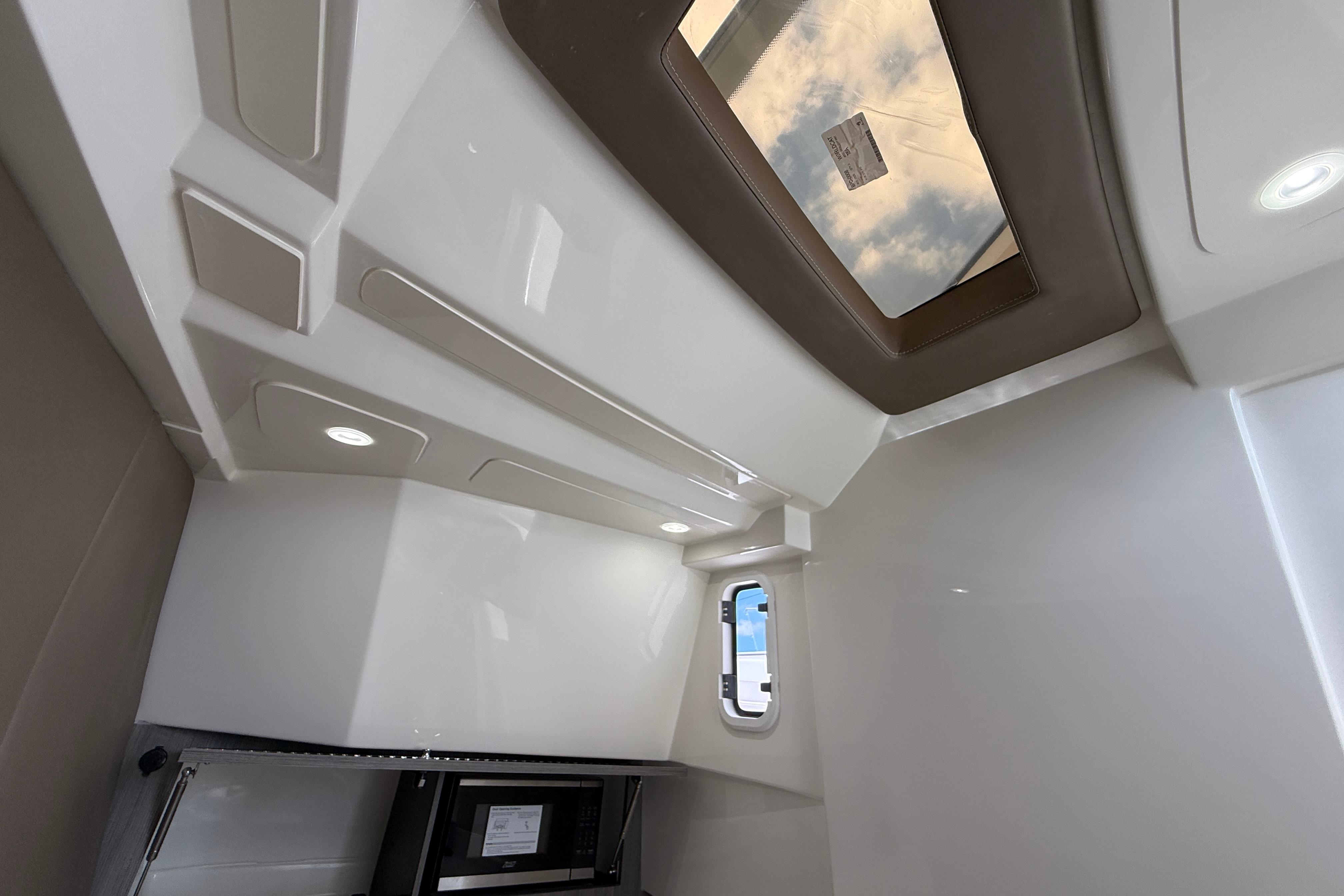 Interior view of 2026 World Cat 400 DC-X Island boat cabin with skylight and modern design.