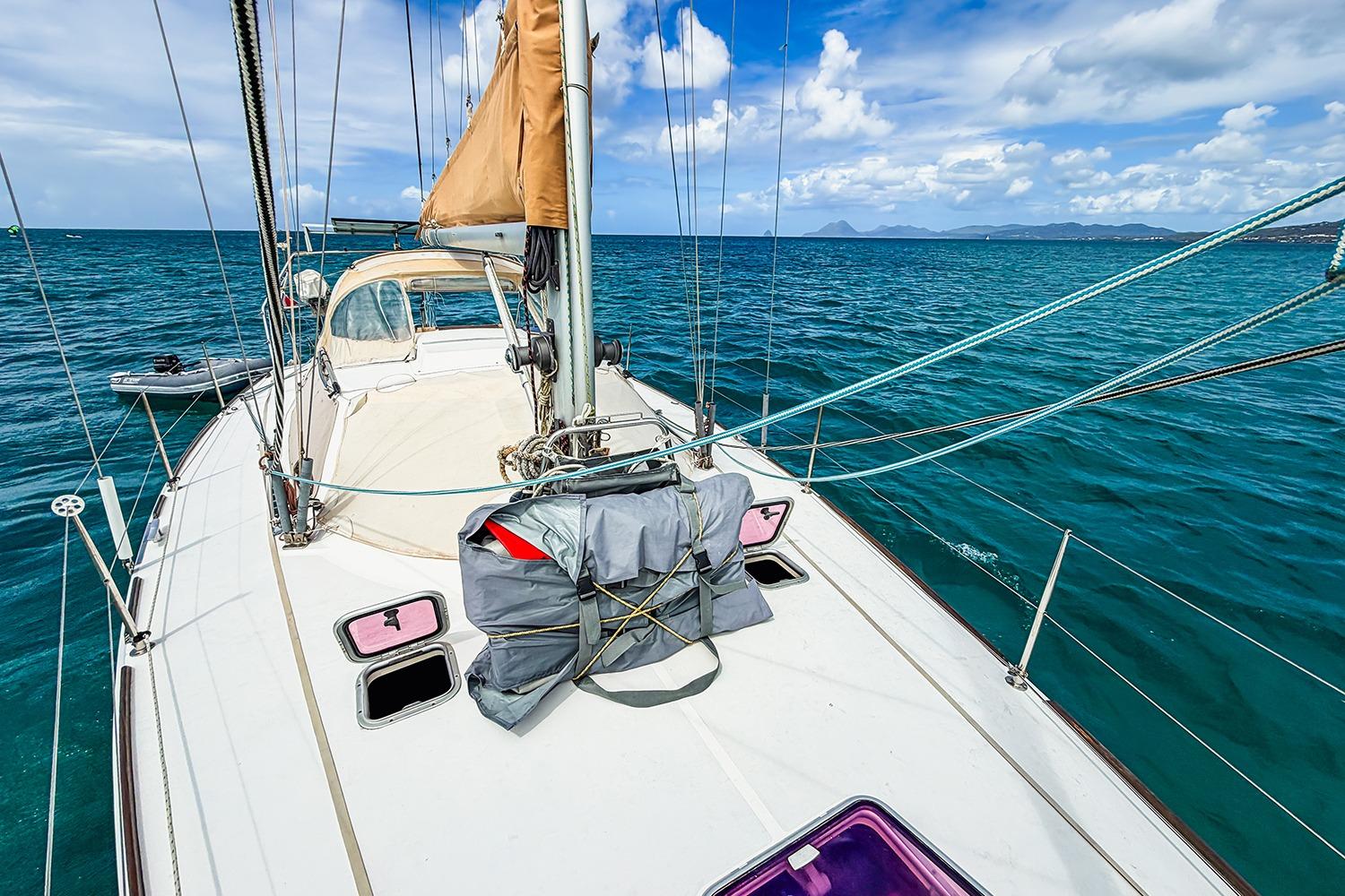 Sailing on RM Yachts 1050, 2006 model, in clear blue ocean waters under a bright sky.