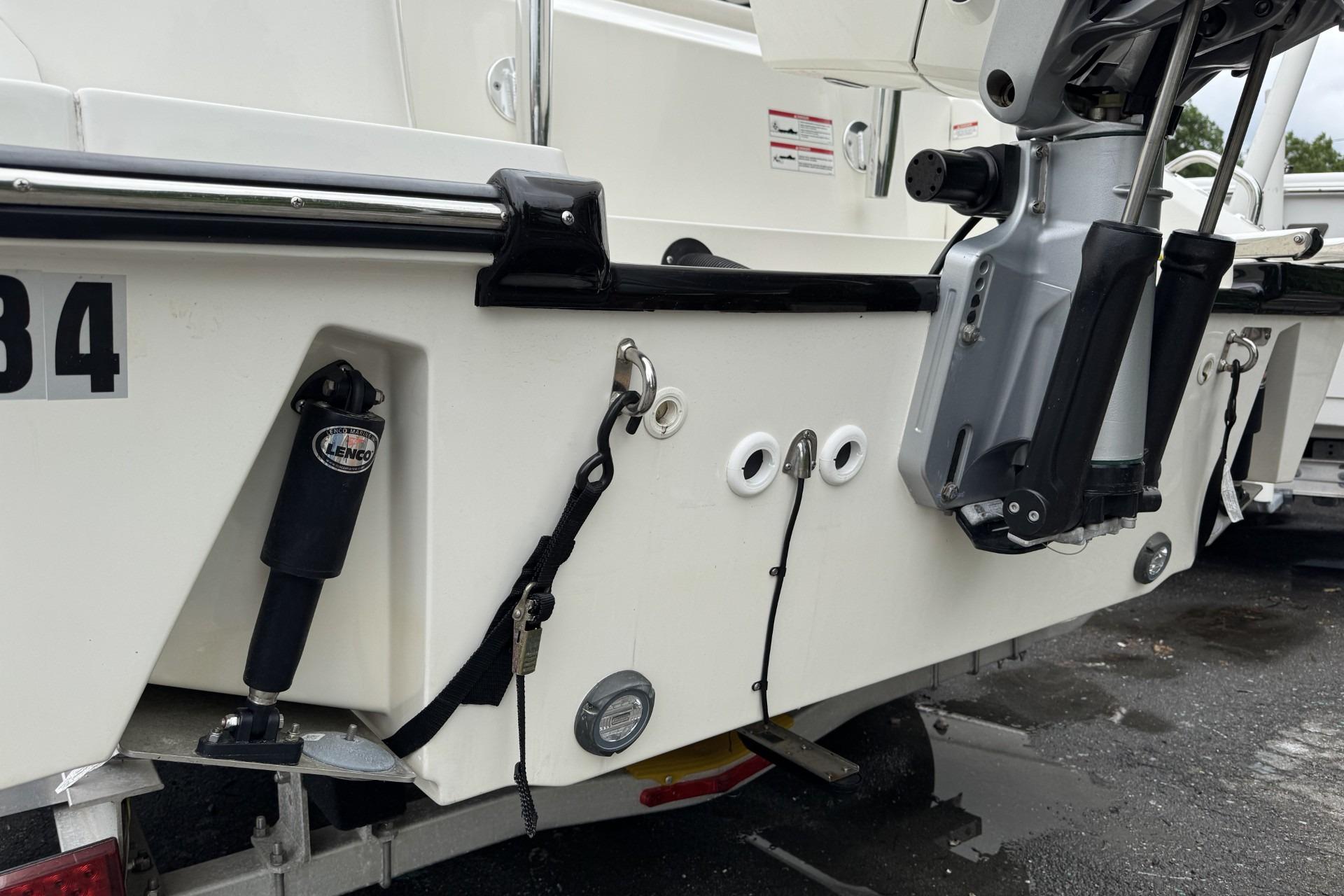 2024 Boston Whaler 230 Outrage boat stern with motor and trim tabs.