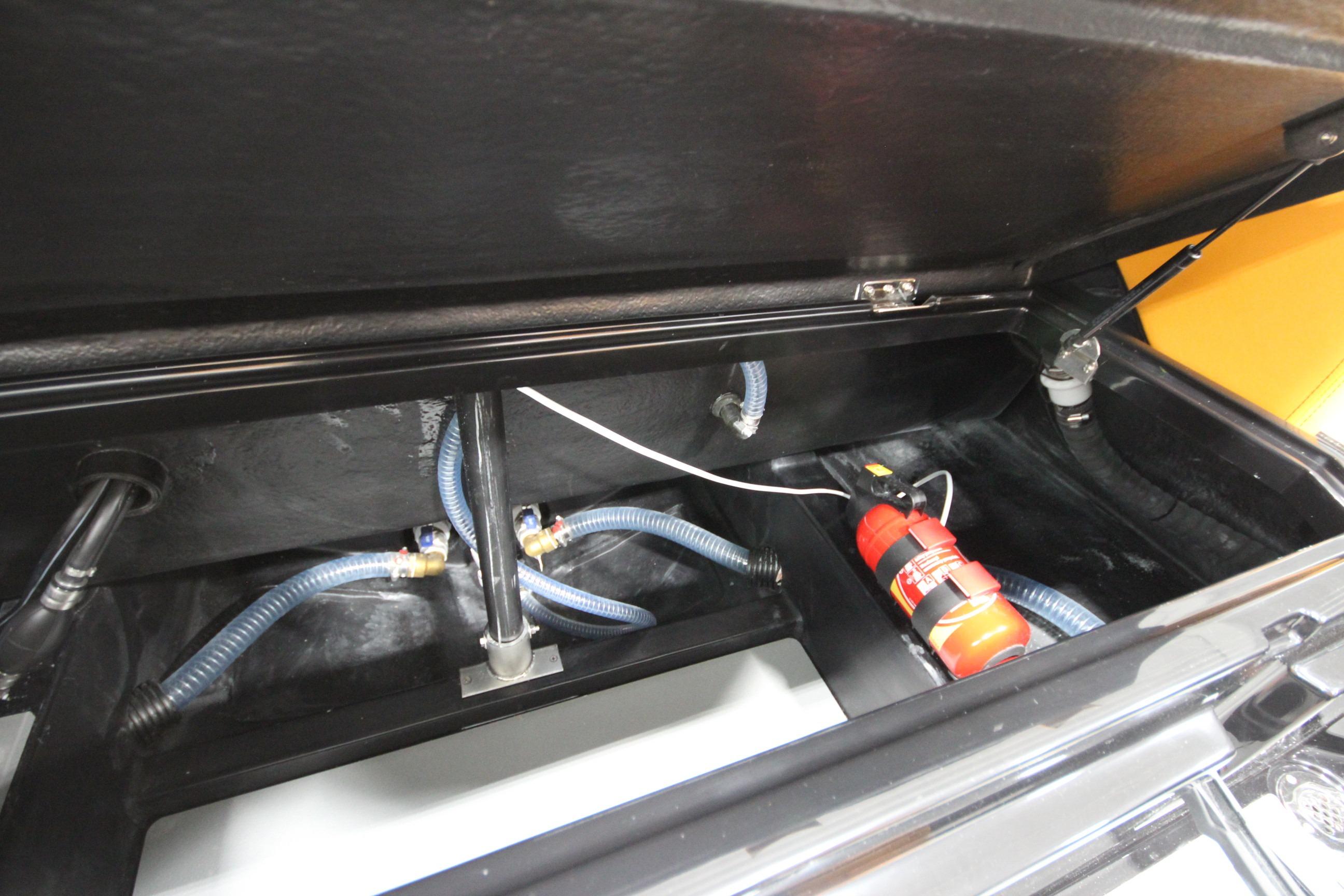 Interior view of Iron 767 (2026) vehicle trunk with hoses and fire extinguisher.