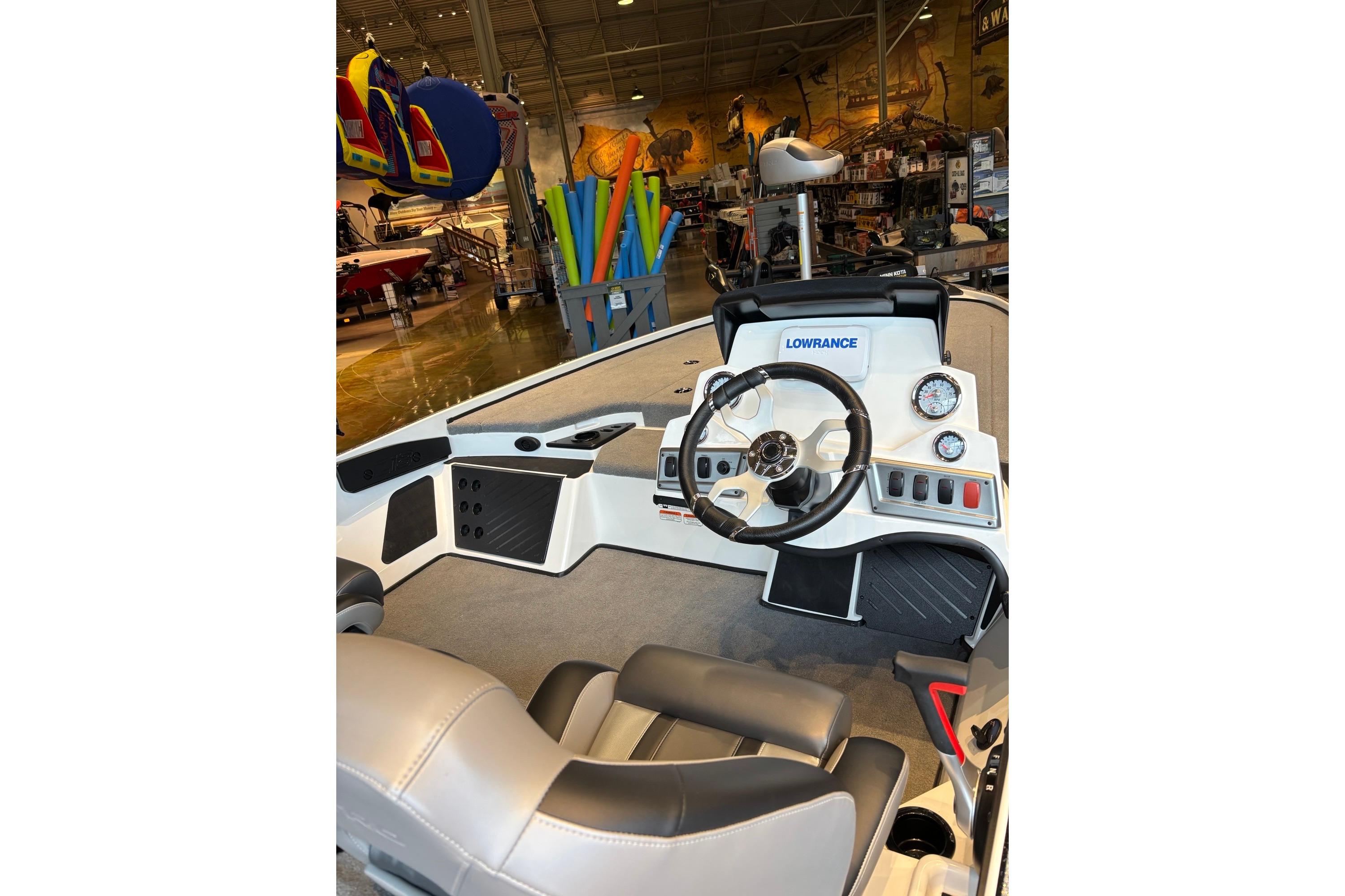 Interior of a 2025 Nitro Z18 boat featuring a steering wheel and dashboard controls.