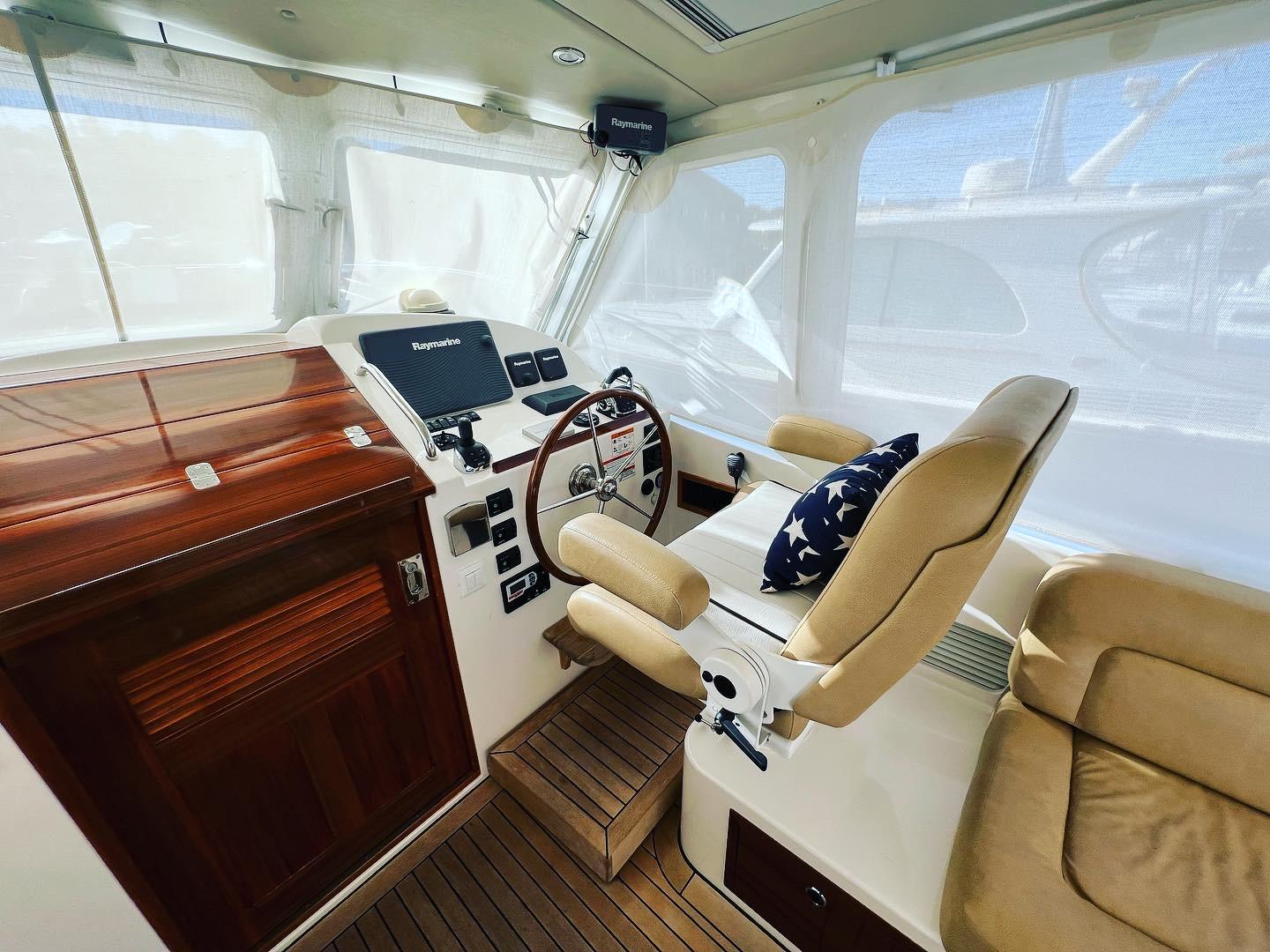 Interior of 2013 MJM 40z Downeast boat with helm and seating area.