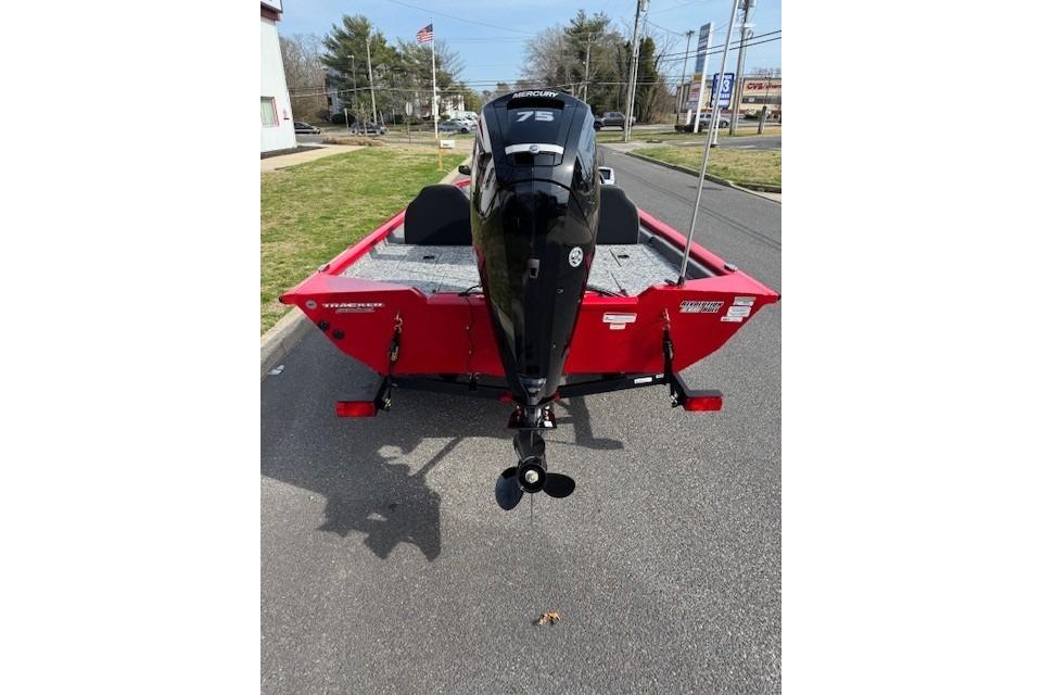 2026 Tracker Pro Team 175 boat with Mercury 75 engine, parked on street.