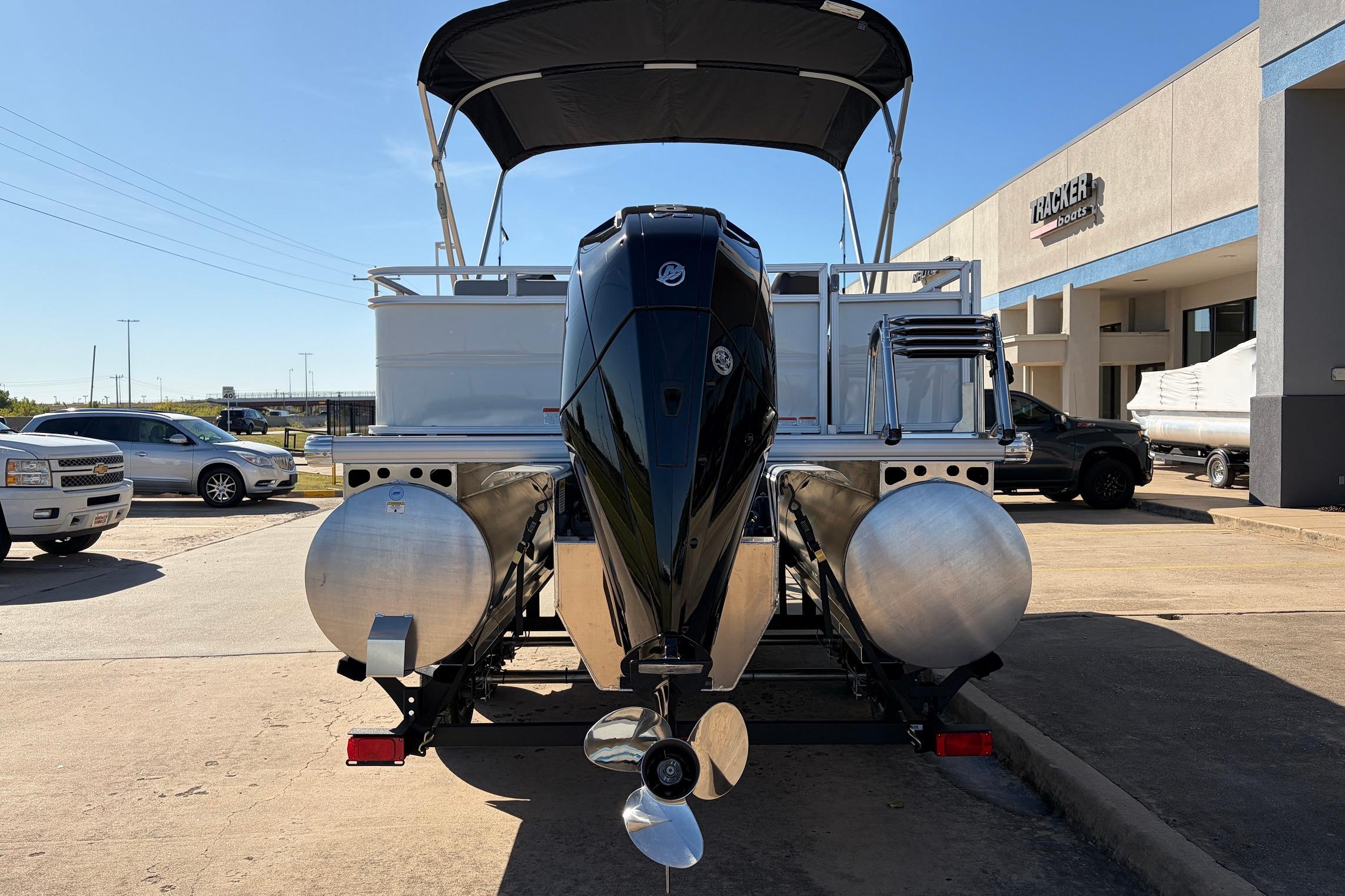 2026 Sun Tracker Party Barge 22 RF XP3 pontoon boat with outboard motor, parked outdoors.